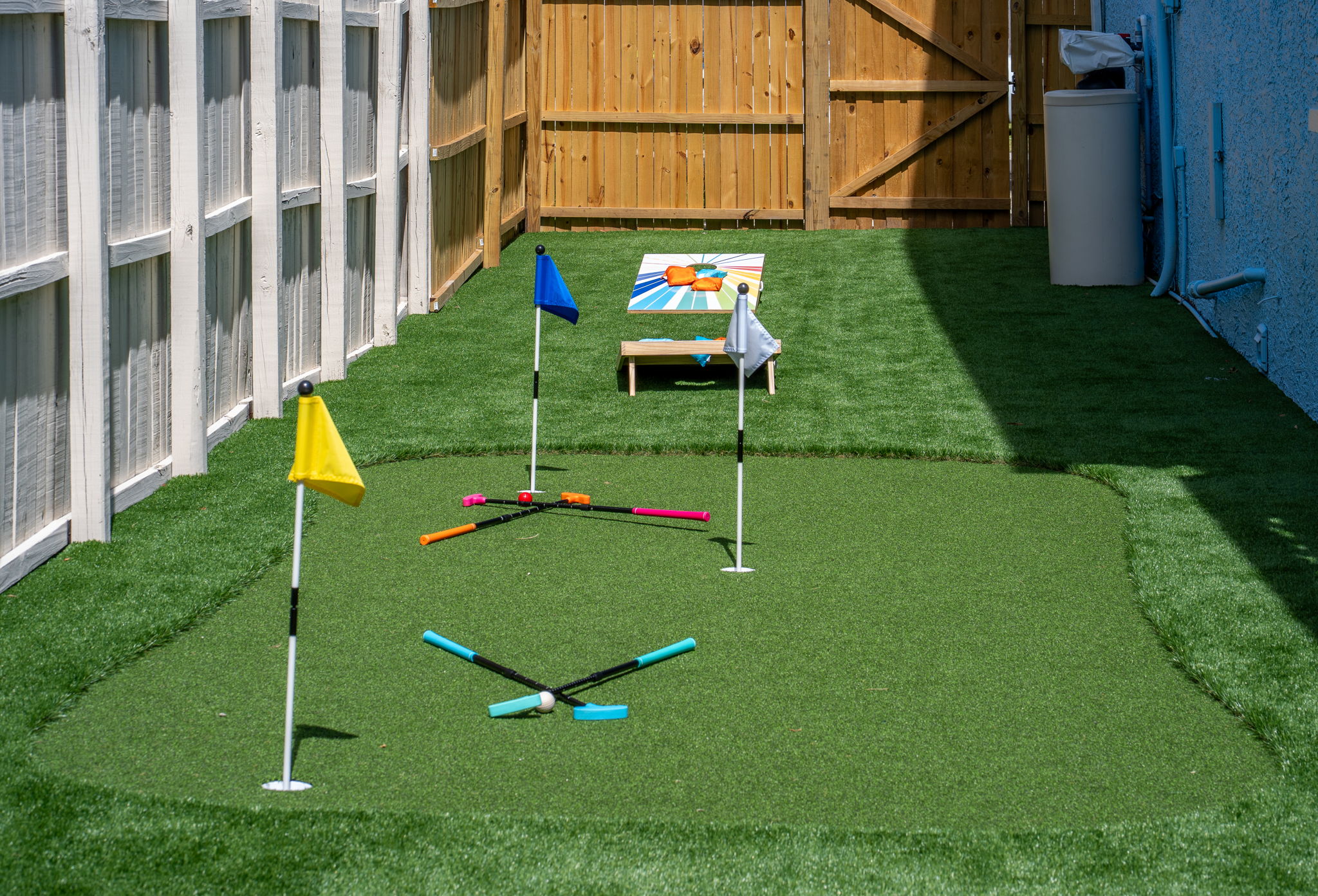 This space proves that even side yards can shine—with artificial turf, classic games, and a whole lot of personality.