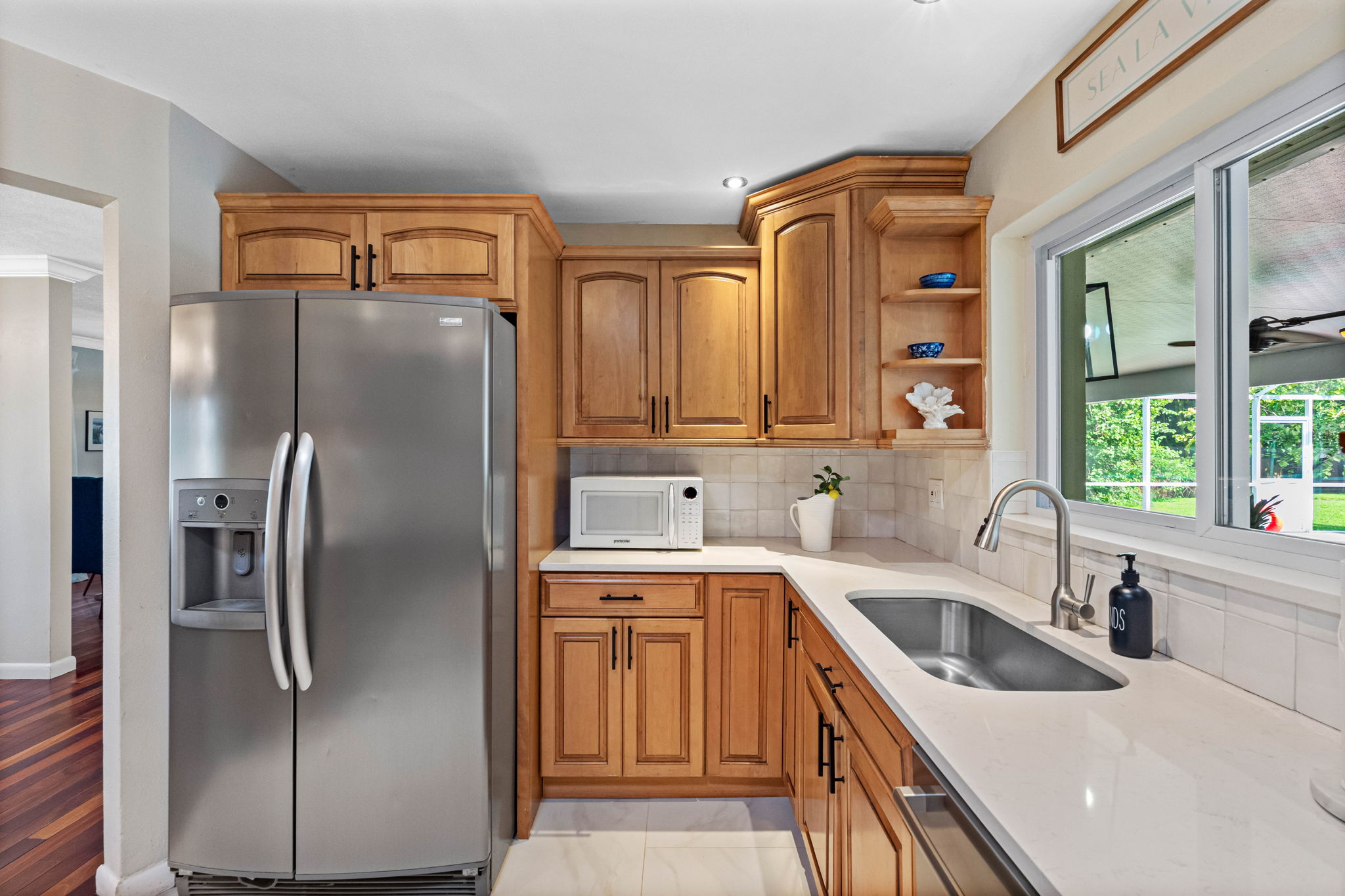 The kitchen features expansive counters, modern appliances, and a warm, inviting atmosphere.
