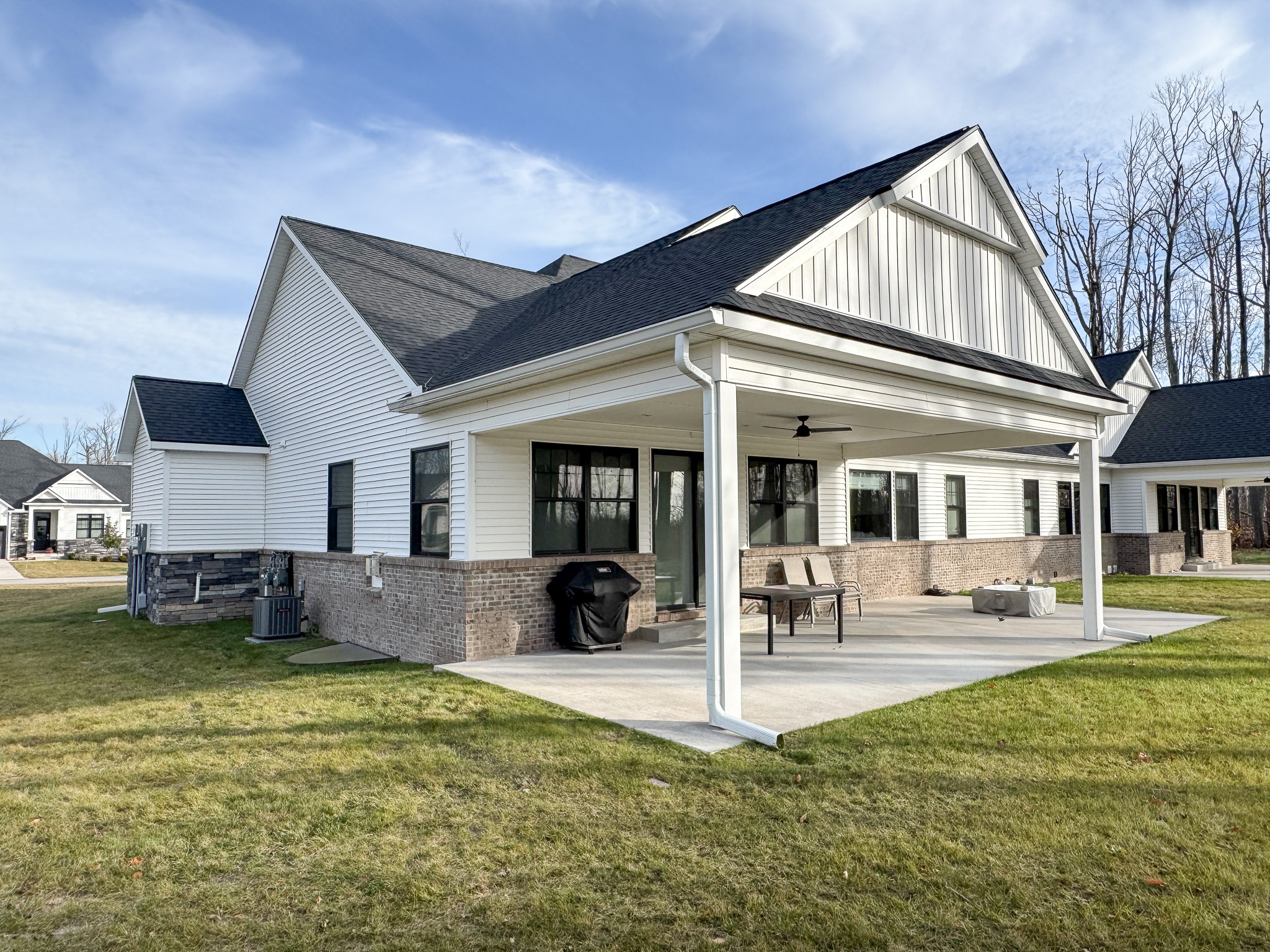 Patio area with gas fireplace, gas grill and comfortable seating in the summertime.