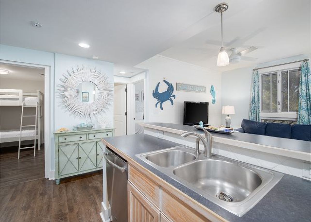Kitchen sink and dishwasher at the breakfast bar, open to the living room and bunk bedroom