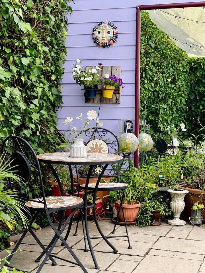 Secluded backyard with a bistro set, perfect for enjoying coffee, wine, or a meal outdoors.