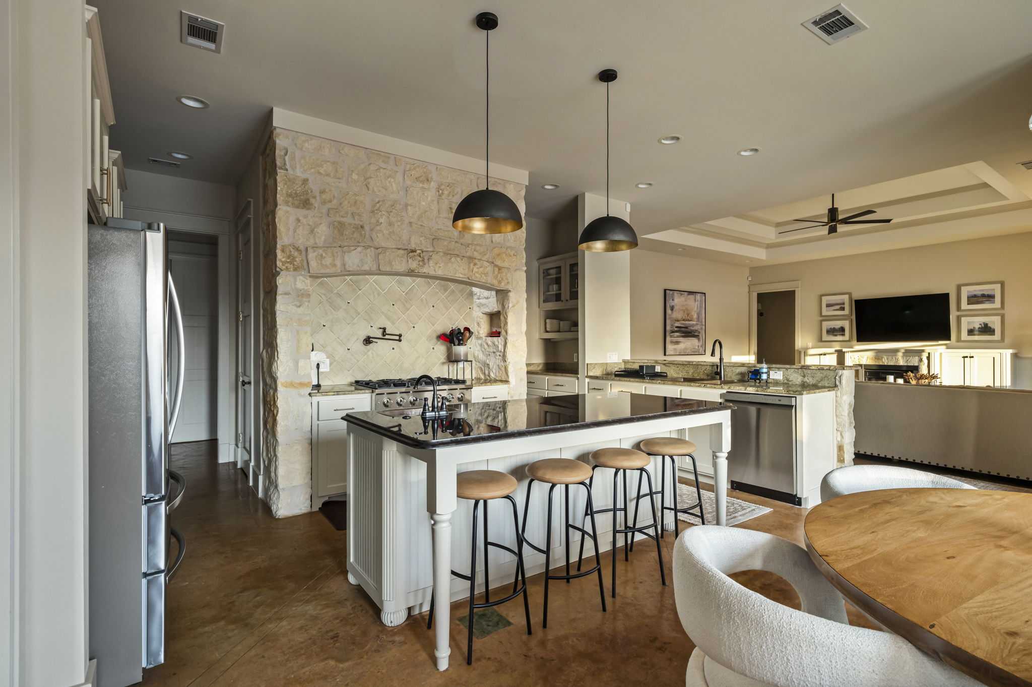 A fully equipped kitchenette includes a fridge, stove, oven, microwave, sink, and utensils for convenient cooking.