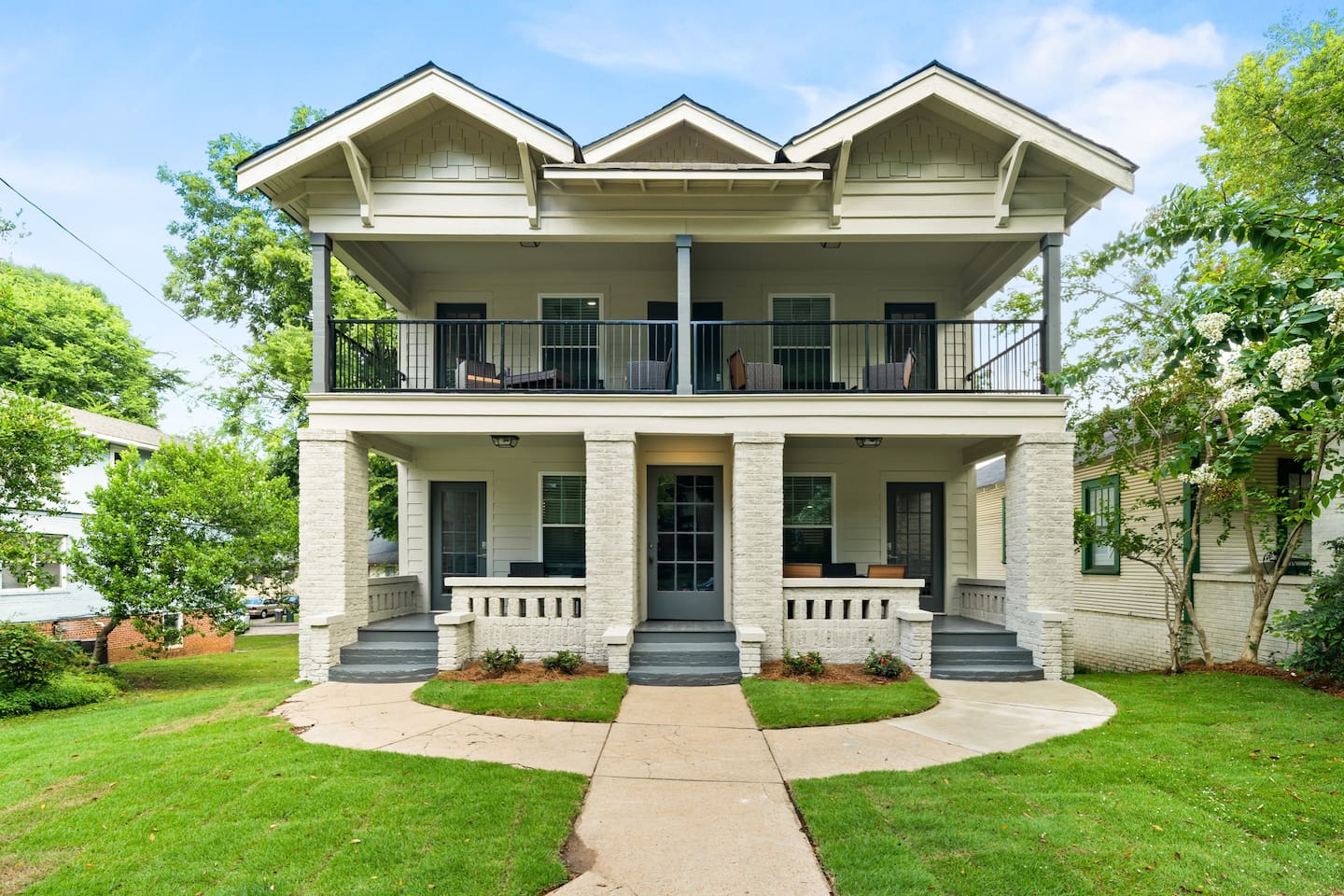 Welcome to Avenue Quads! This inviting view of the right side of the building, featuring Units 2 & 4, sets the stage for a comfortable and stylish stay.