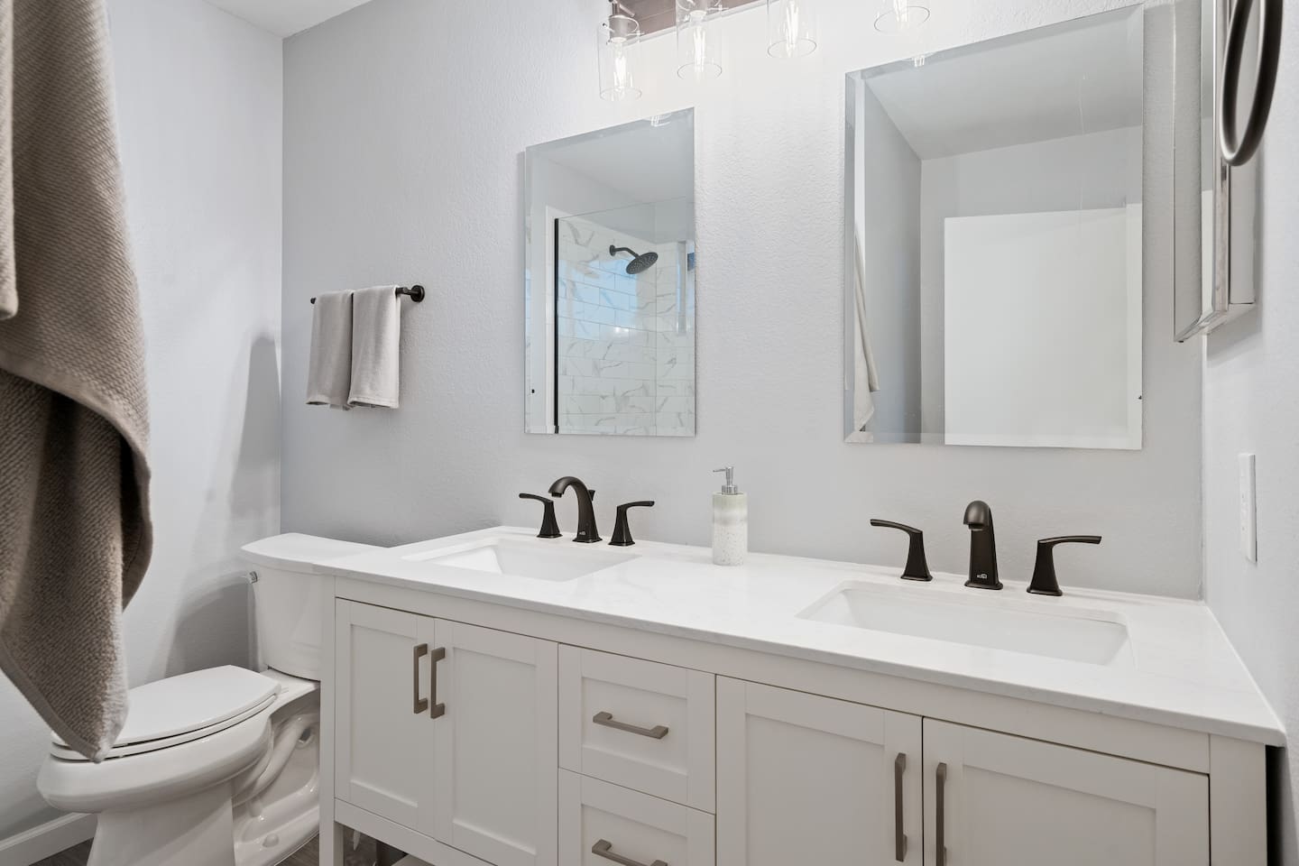 The primary bathroom has two sinks and nice, remodeled finishings.