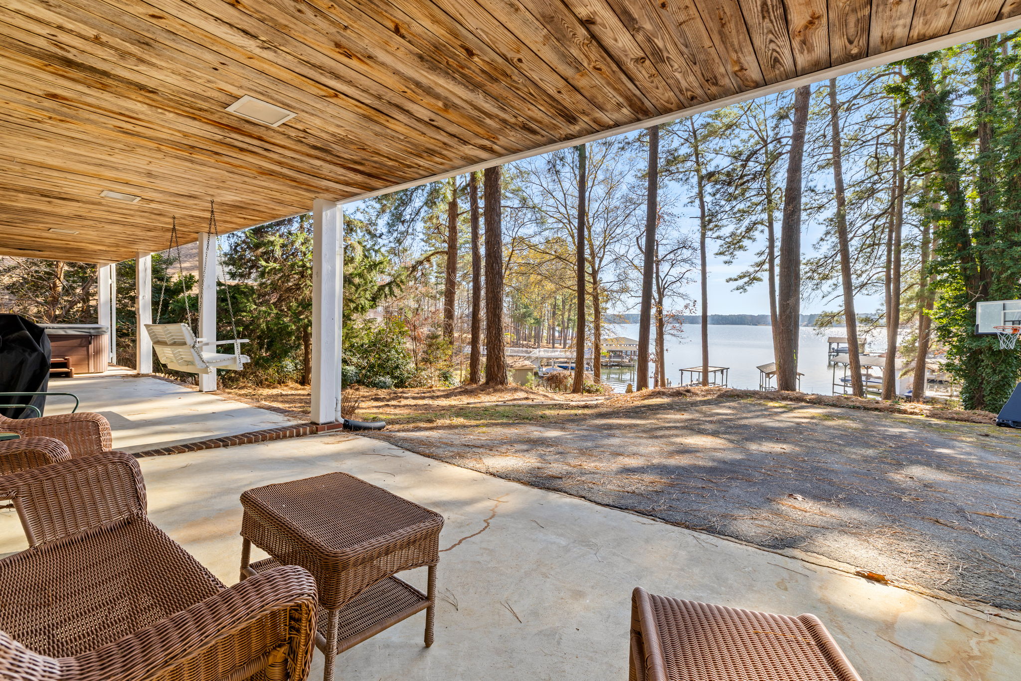 Plenty of seating under the deck to look at the lake, grill dinner or hang out by the hot tub.