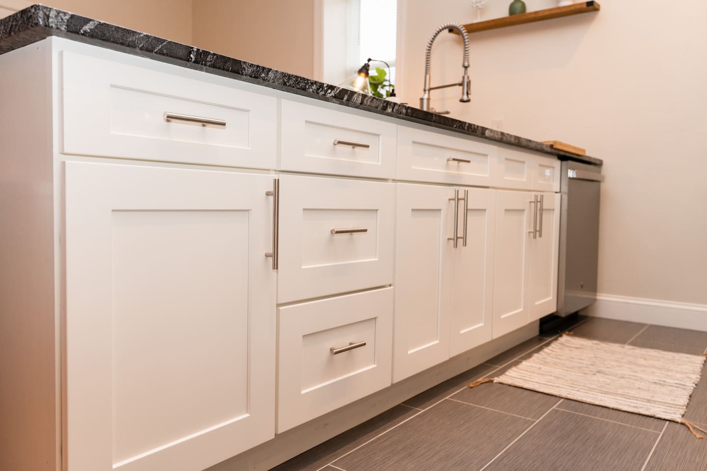 Spacious under-counter kitchen cabinets with ample storage, featuring a sleek sink.