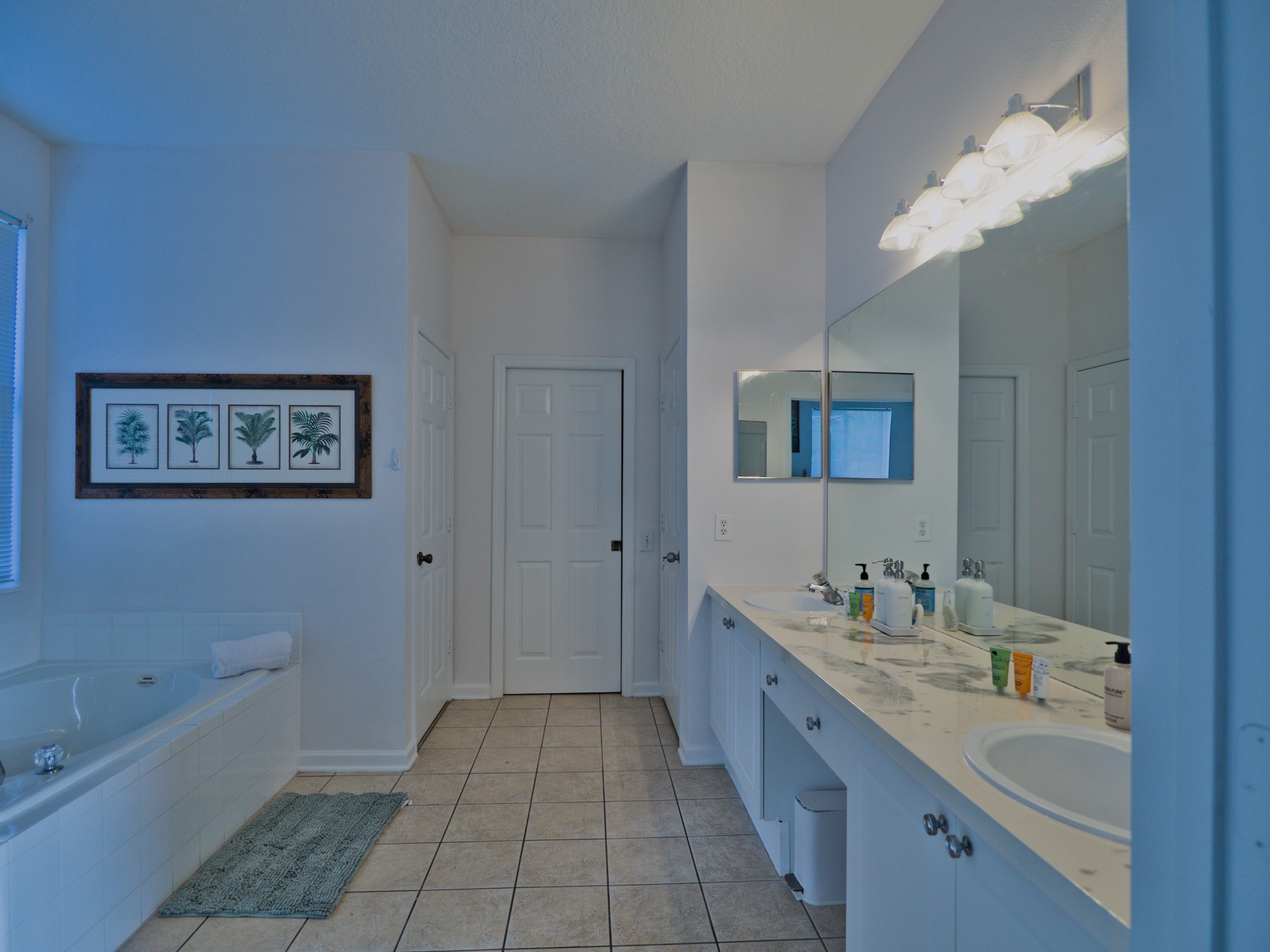 Jungle Book master bathroom with shower, tub, and two sinks.