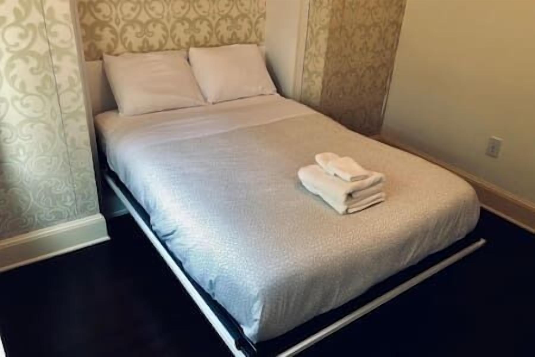 Cozy queen bed, crisp linens, serene design—and a 32" Roku Smart TV for winding down with your favorite shows