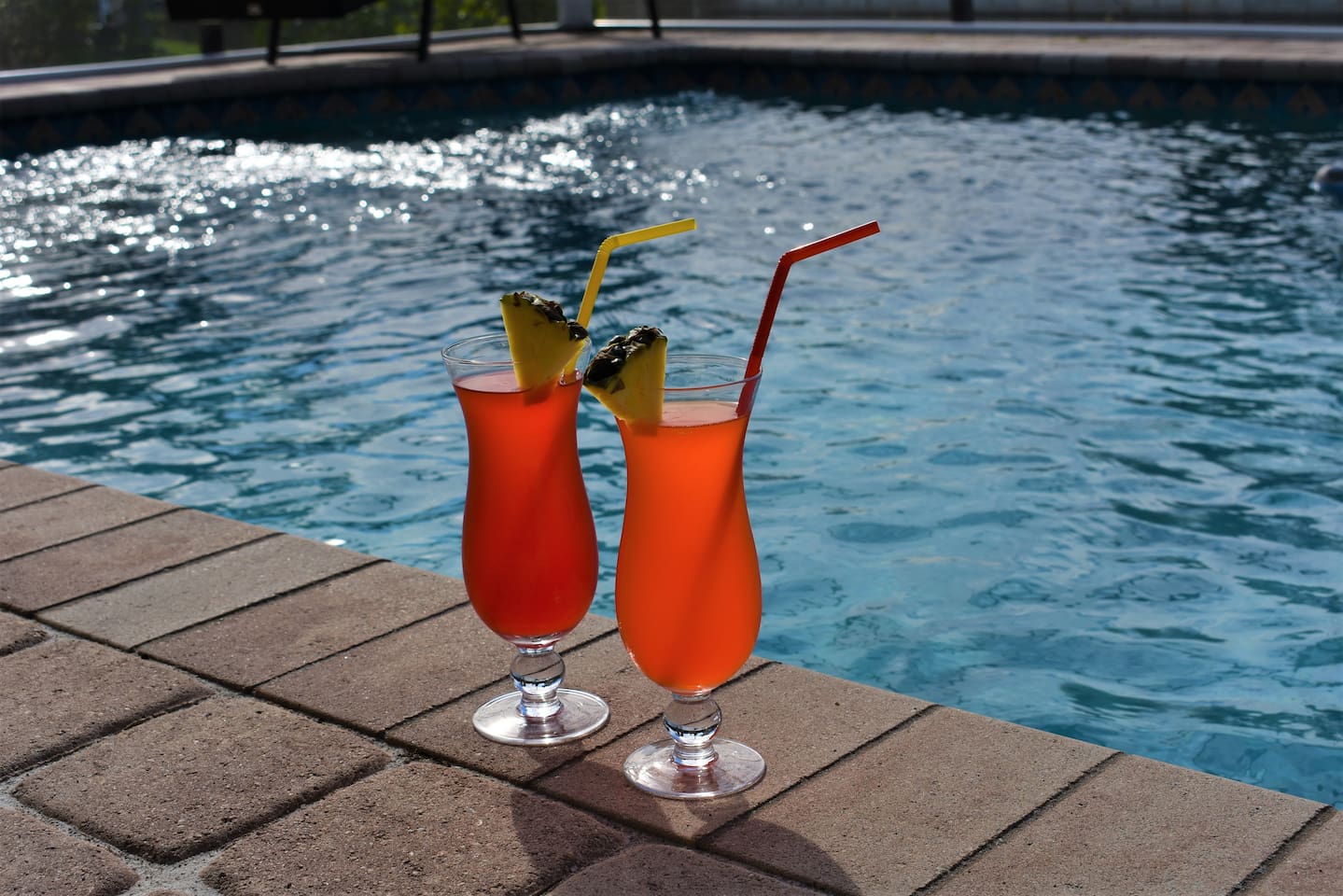 Enjoy a quiet moment poolside with a drink in hand and serene surroundings!