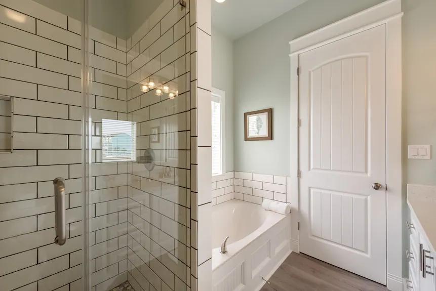 Breezy Point Bathroom 1: Spacious ensuite bath with a full bath setup, offering convenient access from the primary bedroom.