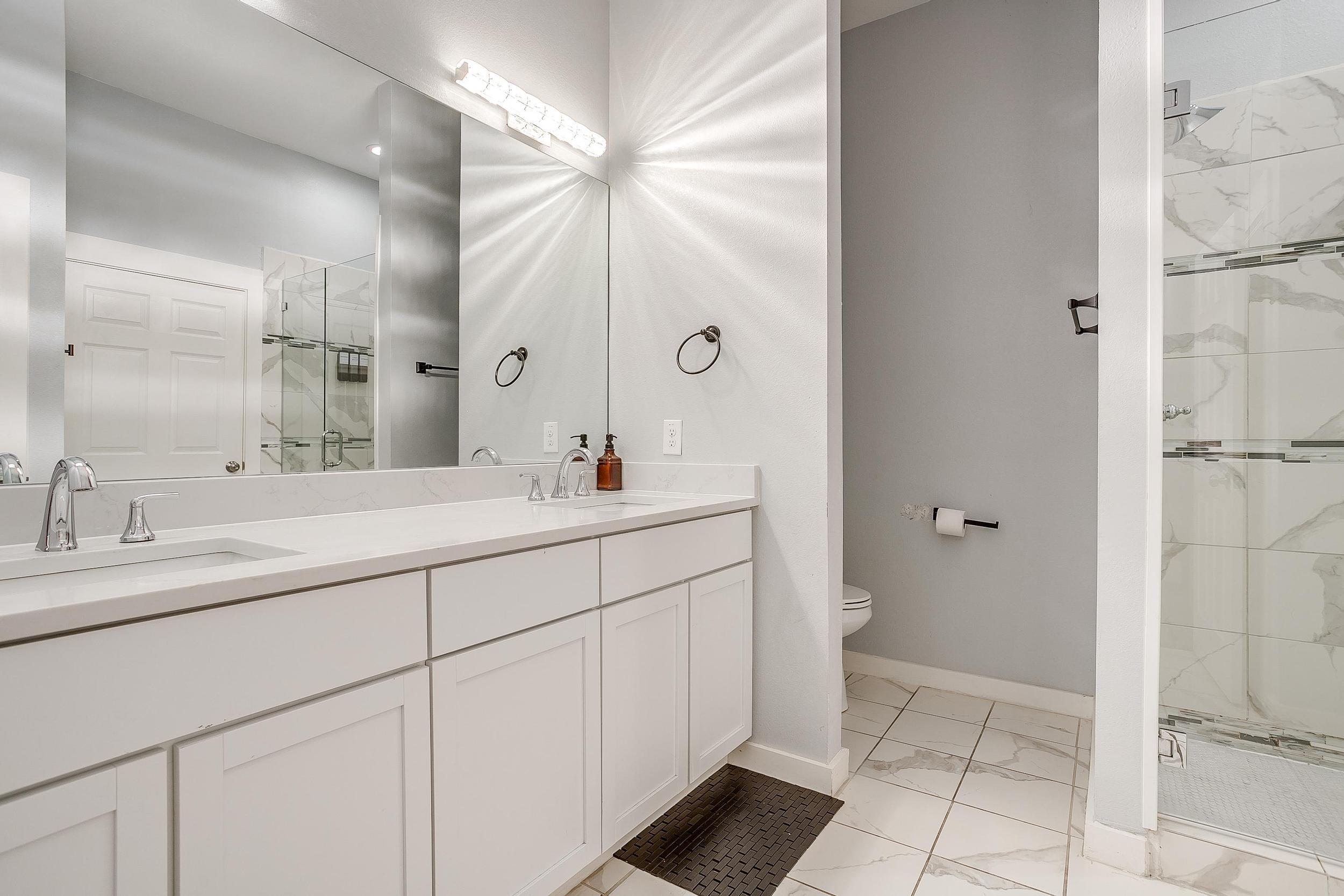 Bright bathroom with essentials provided—easy refresh before a night out.