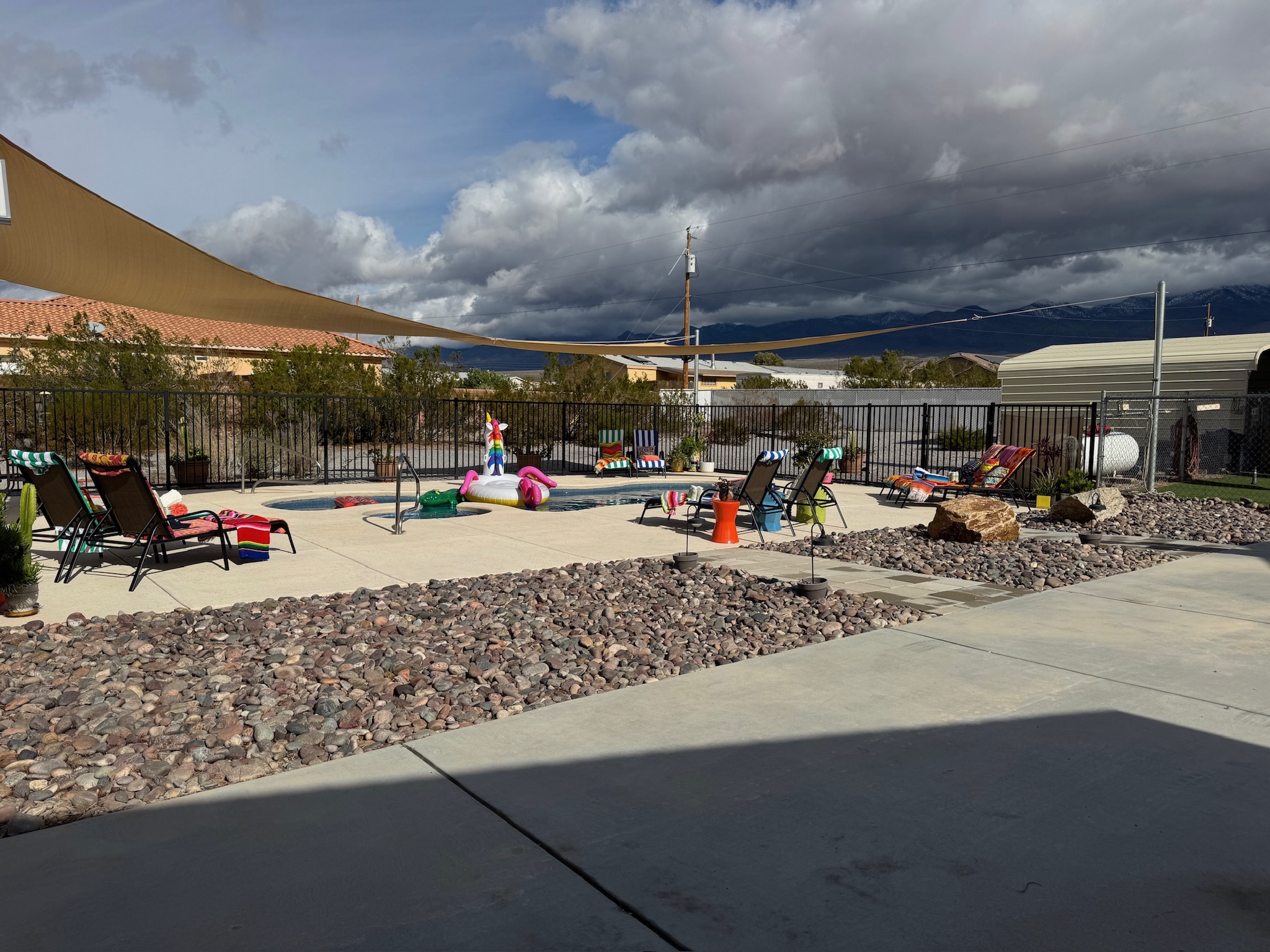 Pool loungers & massive patio space for relaxing in the desert sun.