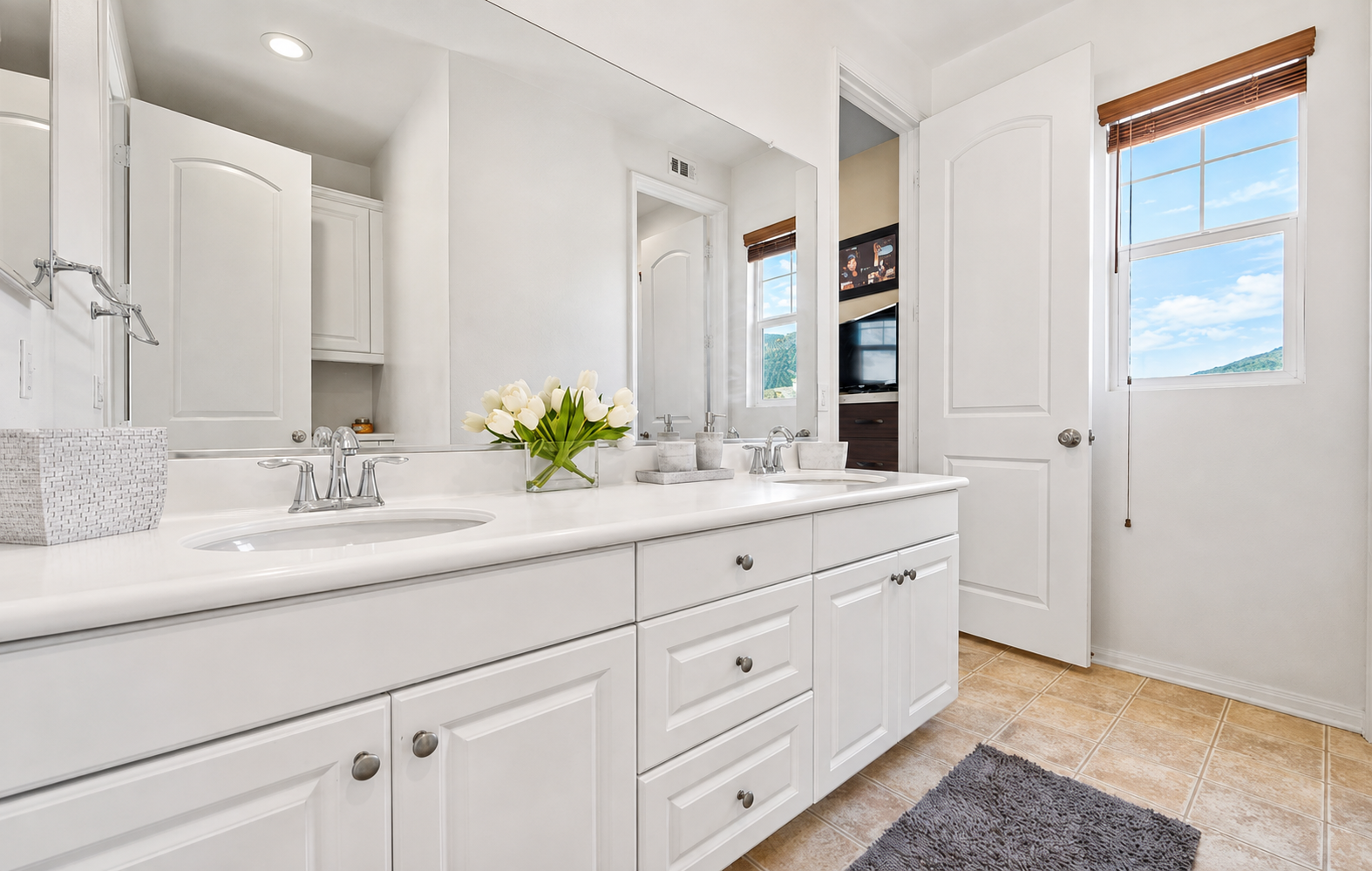 Primary bathroom vanity with double sinks, lots of counter space, and a clean setup for getting ready.