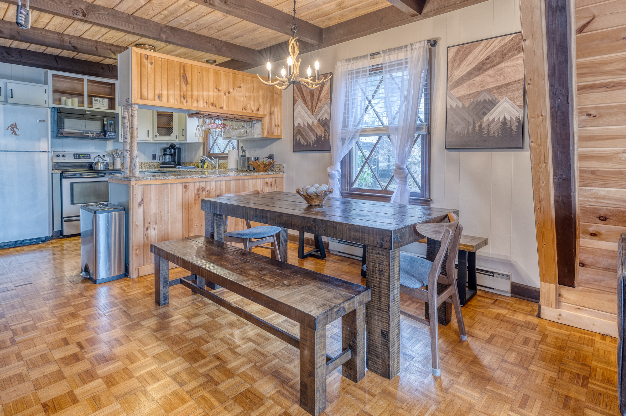 The spacious dining area seats 12, perfect for family meals. Enjoy the warm ambiance and rustic charm, with easy kitchen access for meal prep.