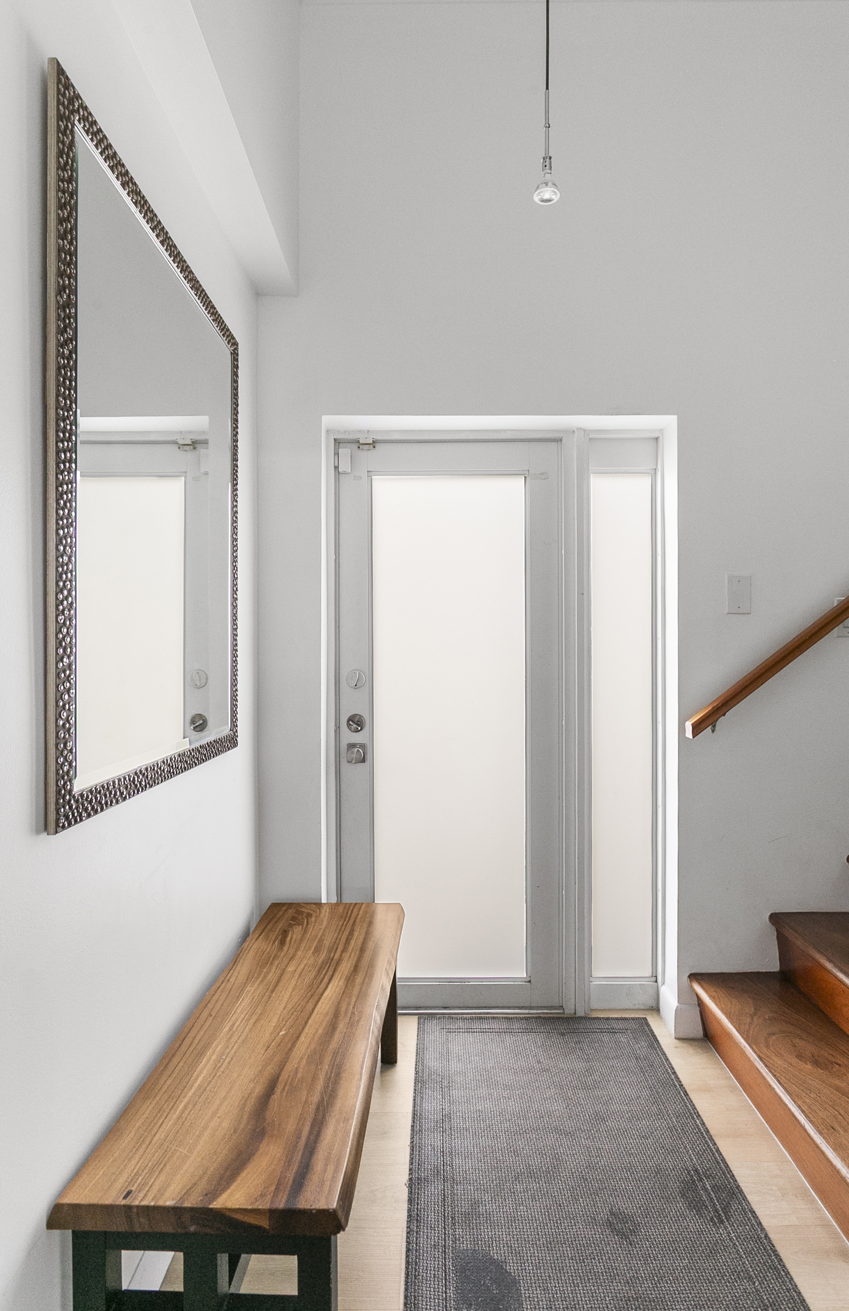 Private entrance foyer with storage space, easily accessible beach gear, and a bench