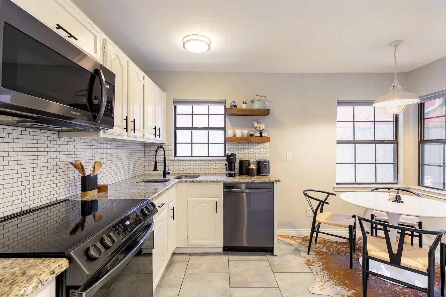 24. Eat-in kitchen with dining table and bright natural light.