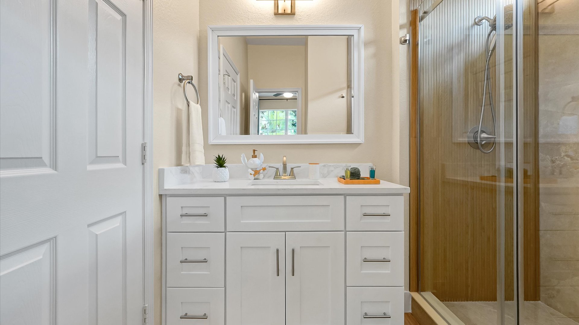 Stitch Queen Retreat Ensuite: Renovated private ensuite with a bright vanity and custom-tiled walk-in shower.