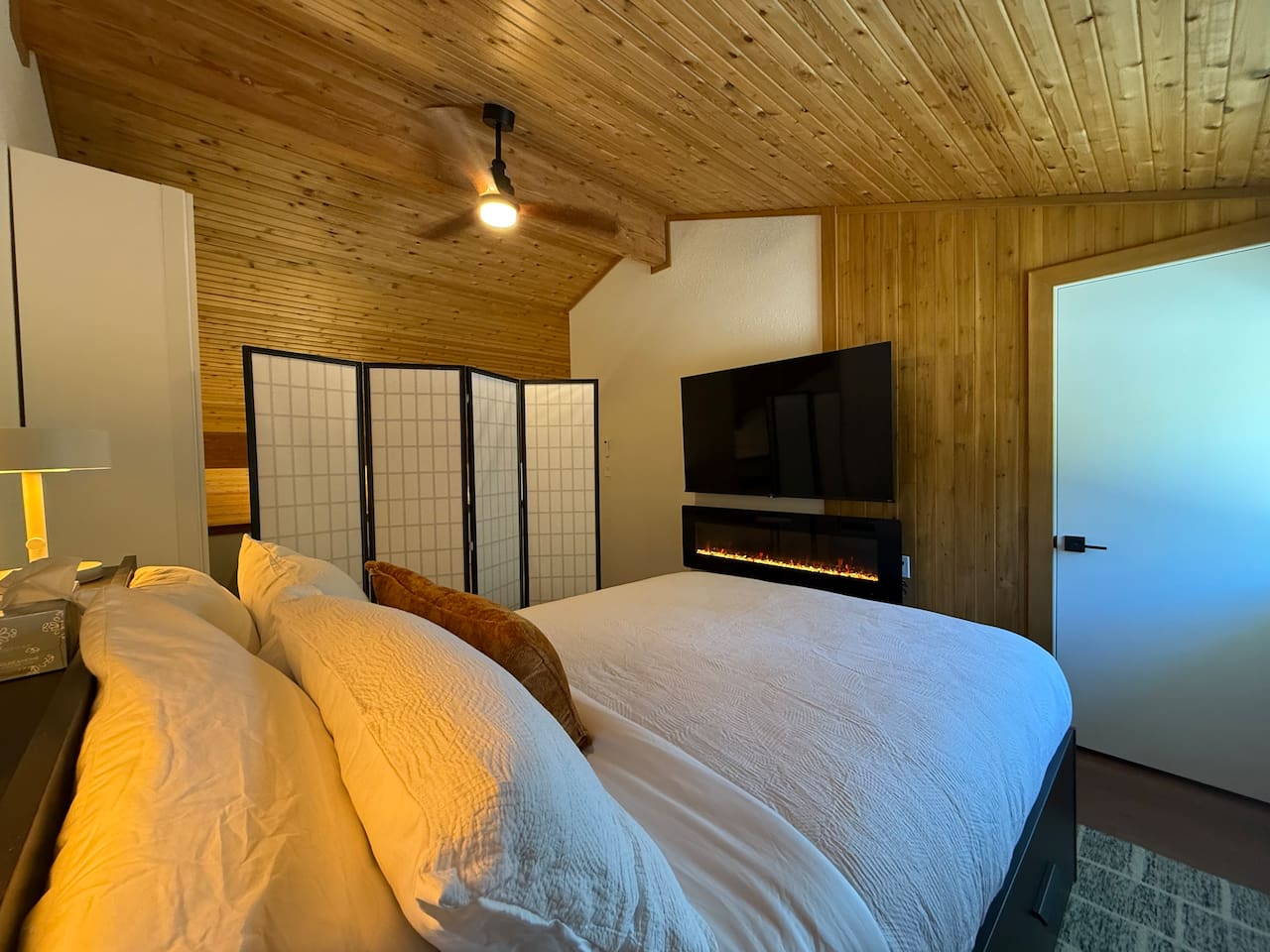 Loft Bedroom Privacy: The loft bedroom, shown with the privacy screens, fireplace and 65" smart TV. 