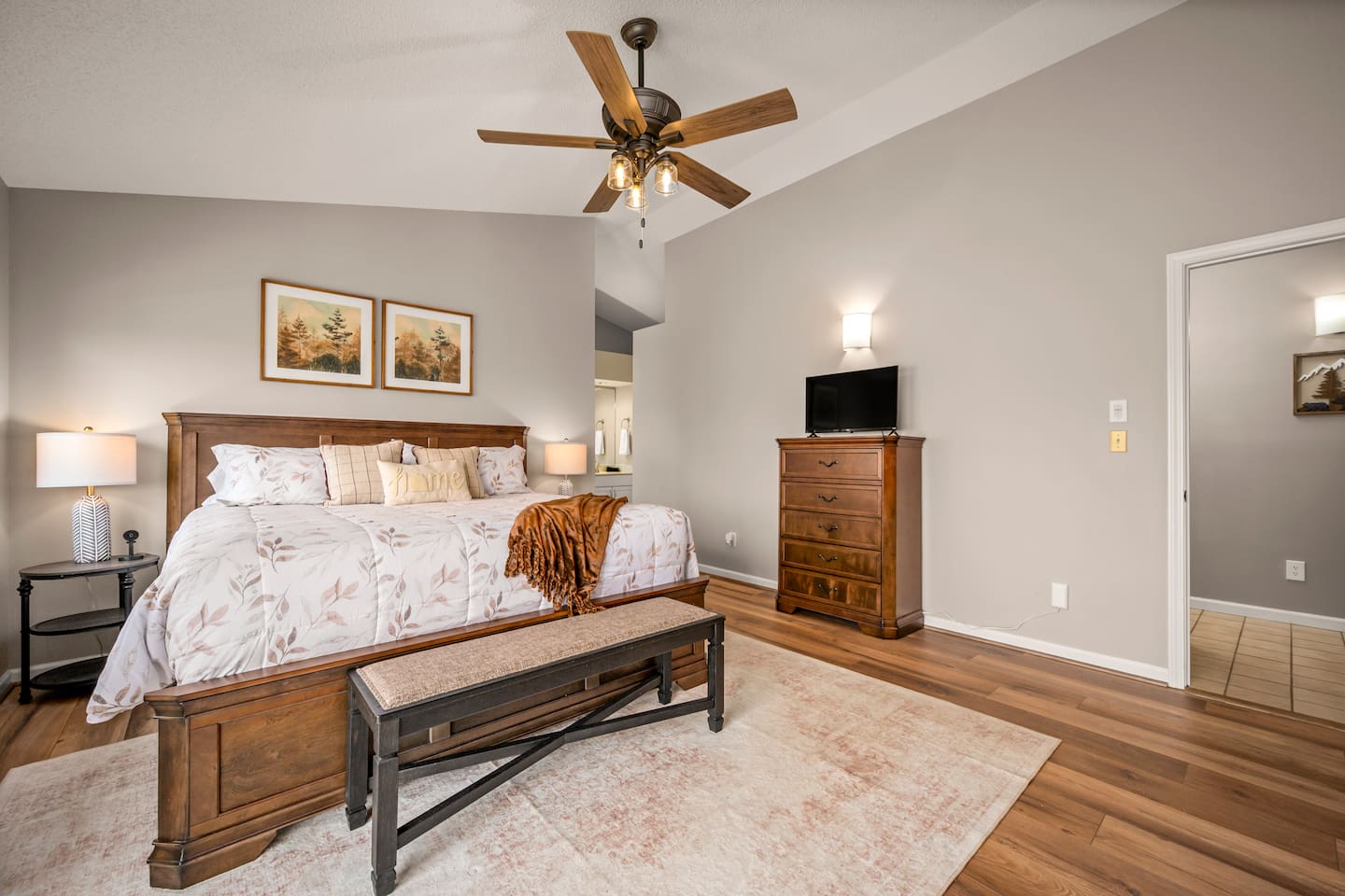 Bedroom #1 on main level of home with en suite bathroom and deck access 