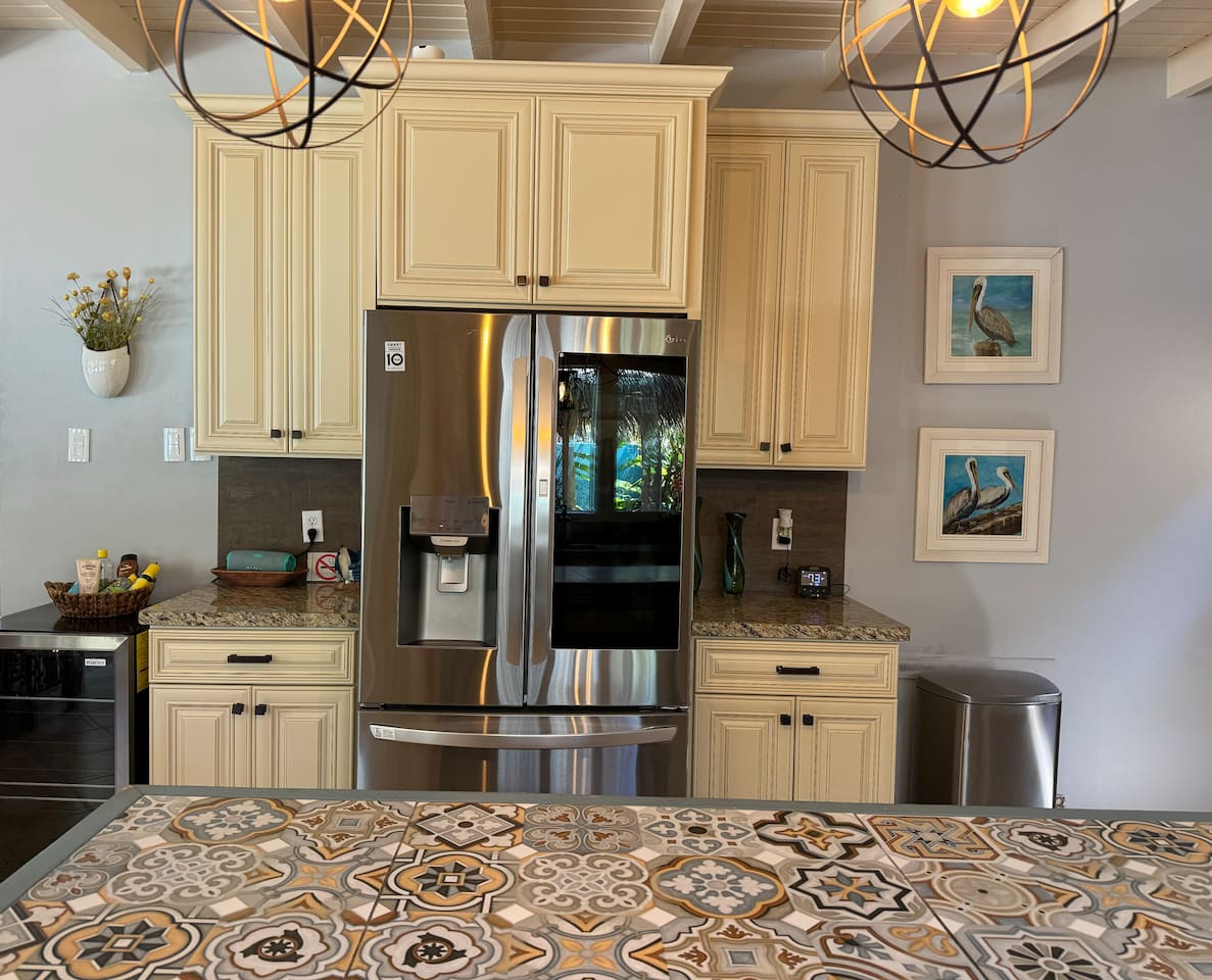 Full sized refrigerator/freezer with ice maker and water dispenser and wine refrigerator.