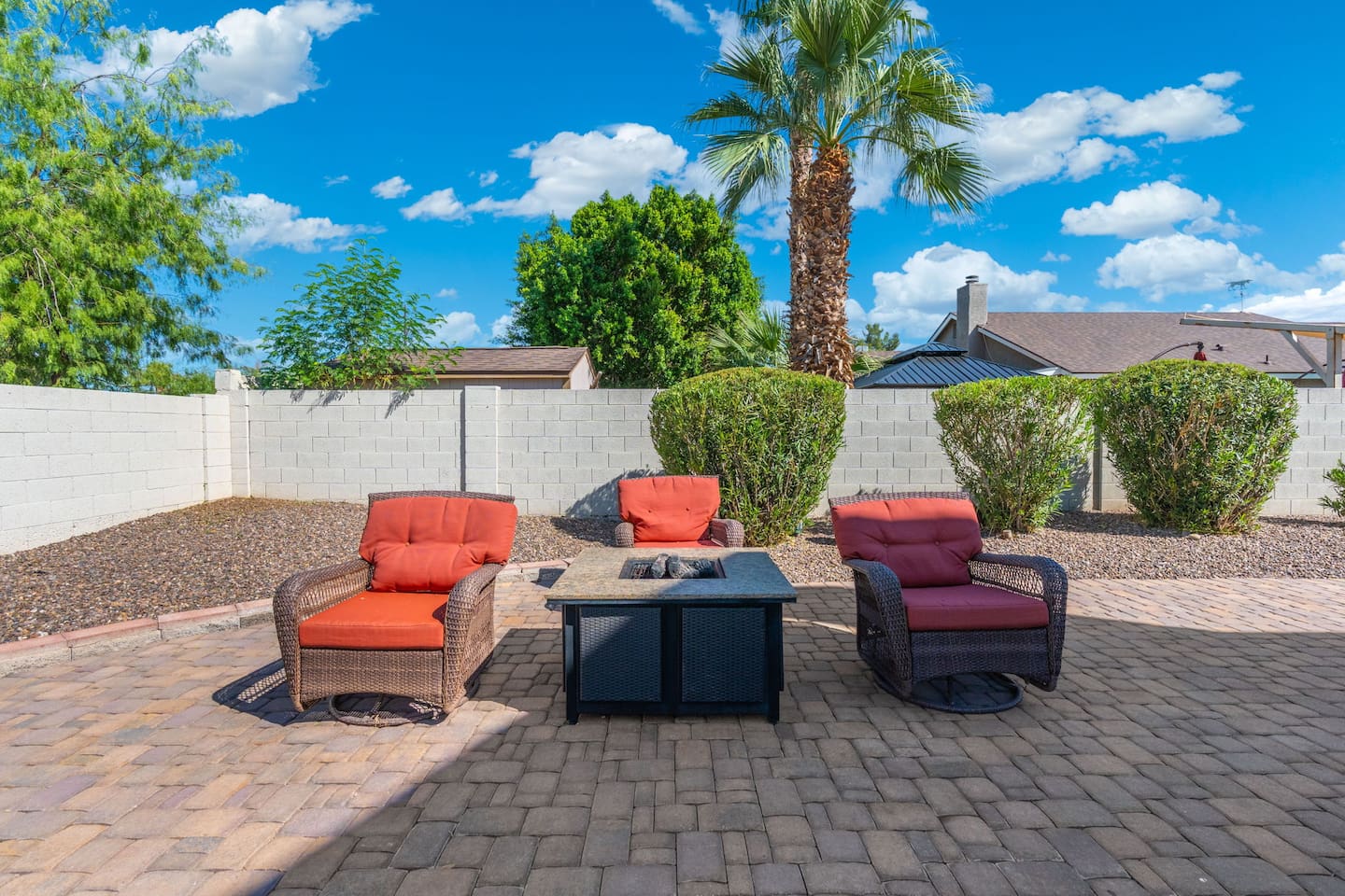 Gather around the fire pit under swaying palms and open sky.