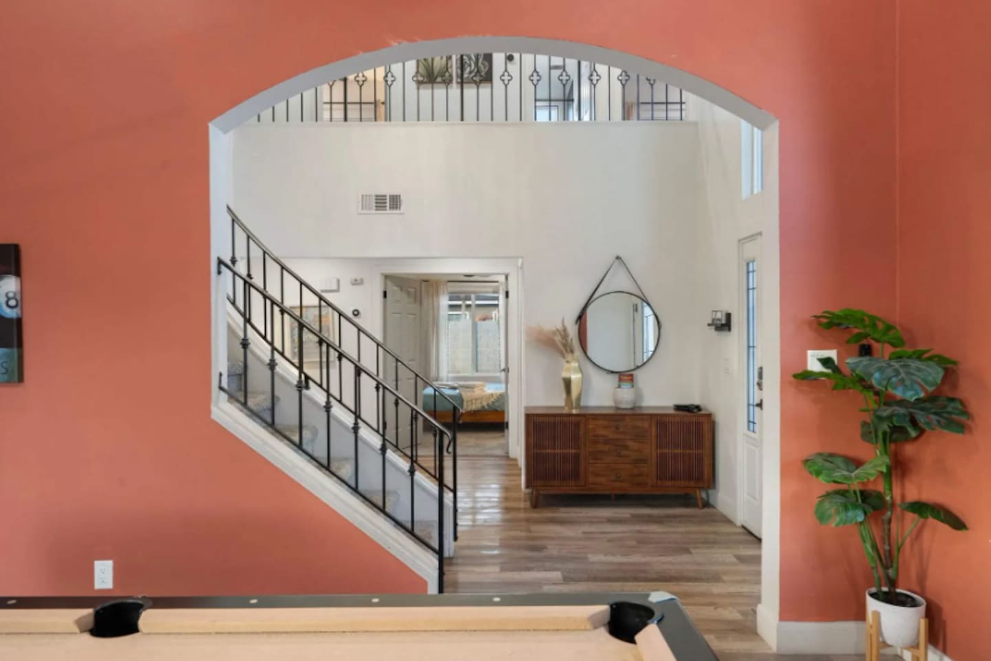 rand entry foyer with soaring ceilings, arched architectural details, and direct stair access.