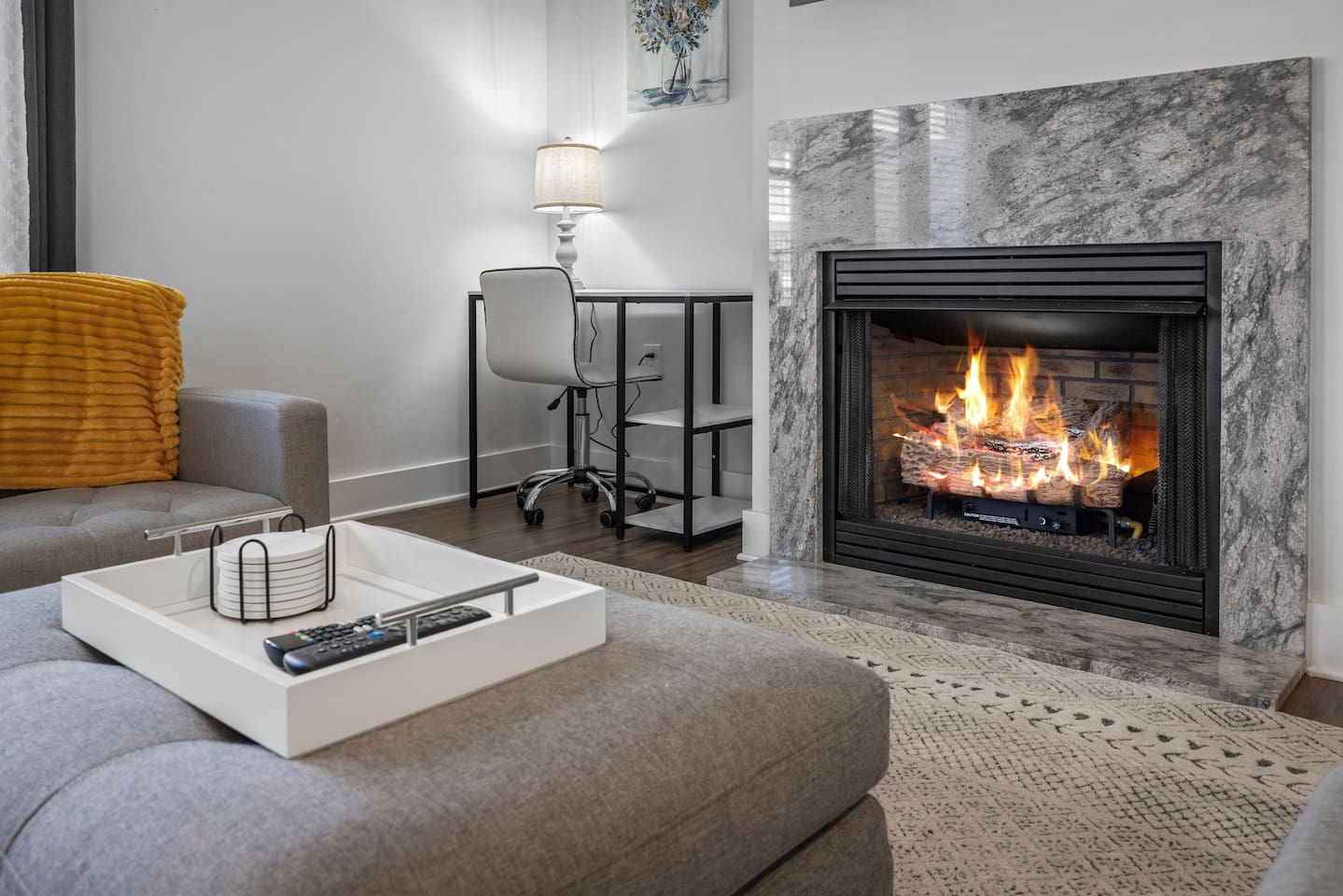 A dedicated desk corner paired with a fireplace makes working from home warm and inviting.