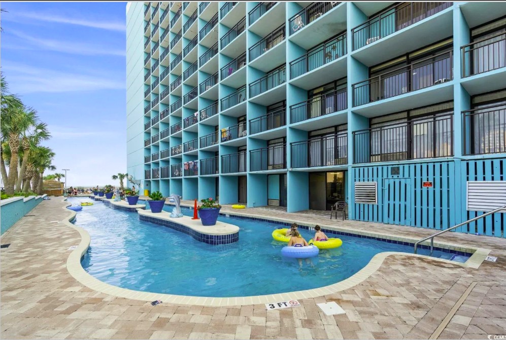 Behold the breathtaking view, where the azure waters of the pool seamlessly blend with the vast expanse of the ocean, creating a true seaside paradise.