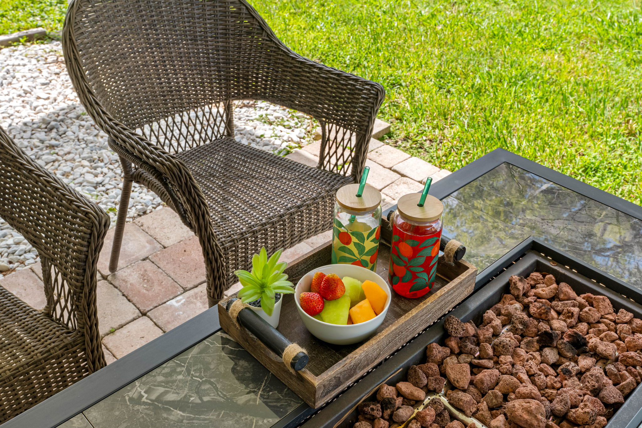 Comfortable wicker seating and a stylish dining set make this patio feel like an outdoor living room, complete with calming water views.