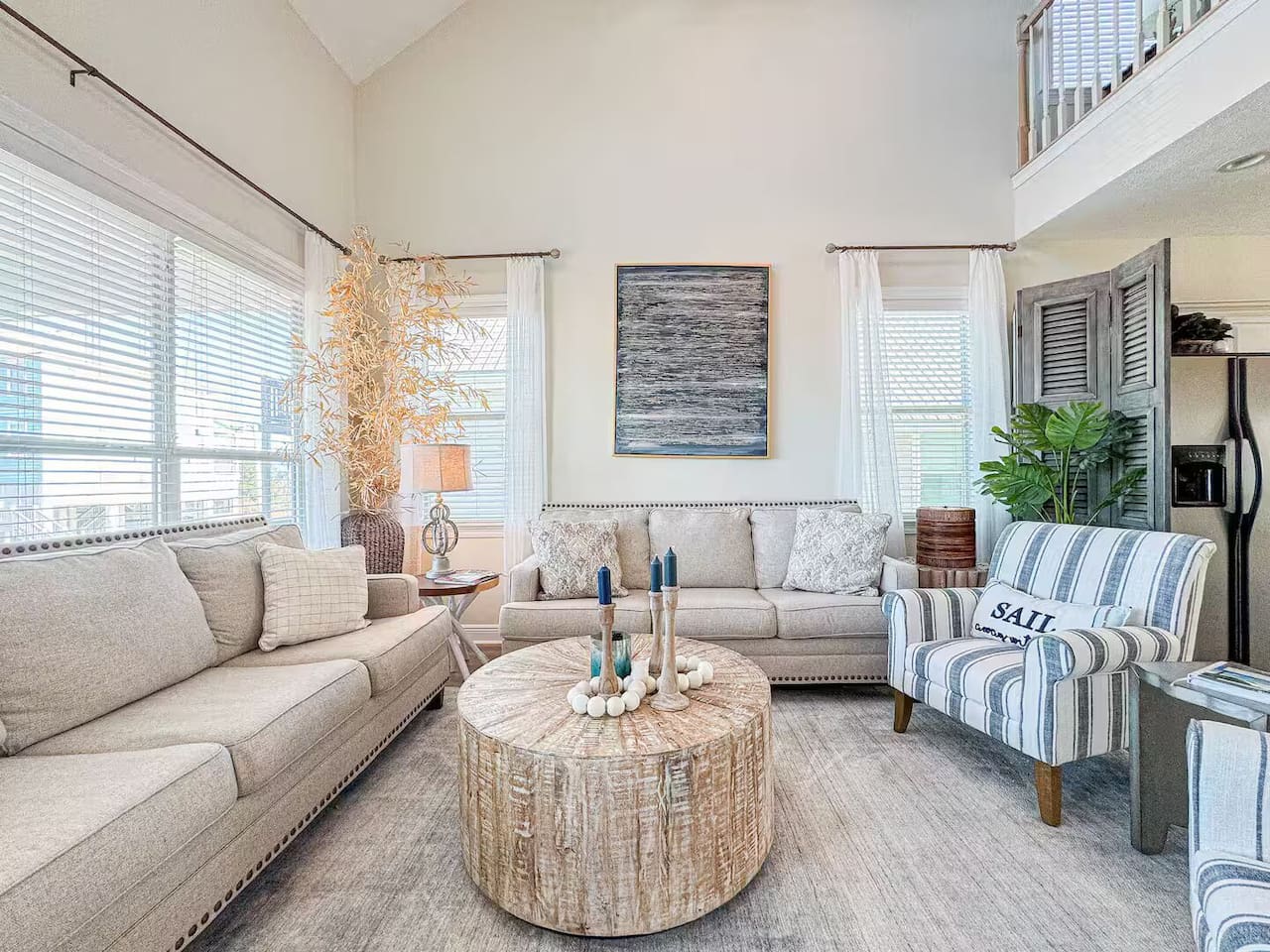 Beautifully designed living area with vaulted ceilings, coastal decor, and plenty of room to unwind in style.