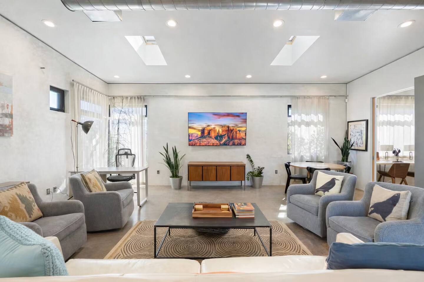 Bright, modern living room with comfortable seating, clean design, and vibrant artwork — a perfect space to relax and unwind.