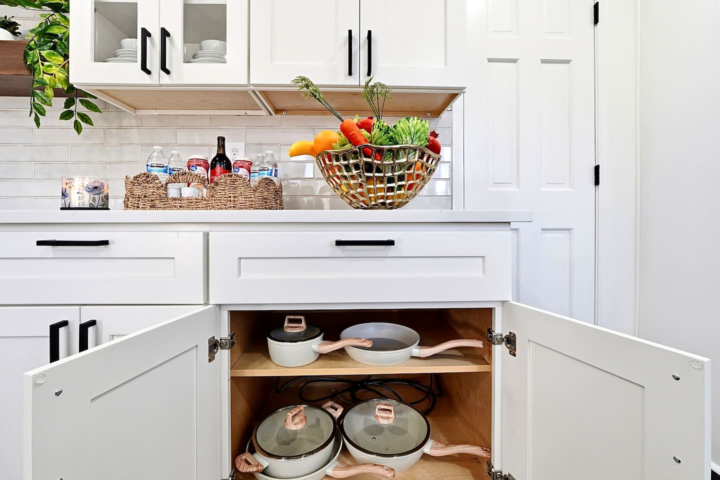 Bright white kitchen with a sleek, extended layout and ample counter space. The long layout offers plenty of countertop space, perfect for cooking, prepping, and everyday meals. Fully stocked with everything you need for a comfortable stay!
