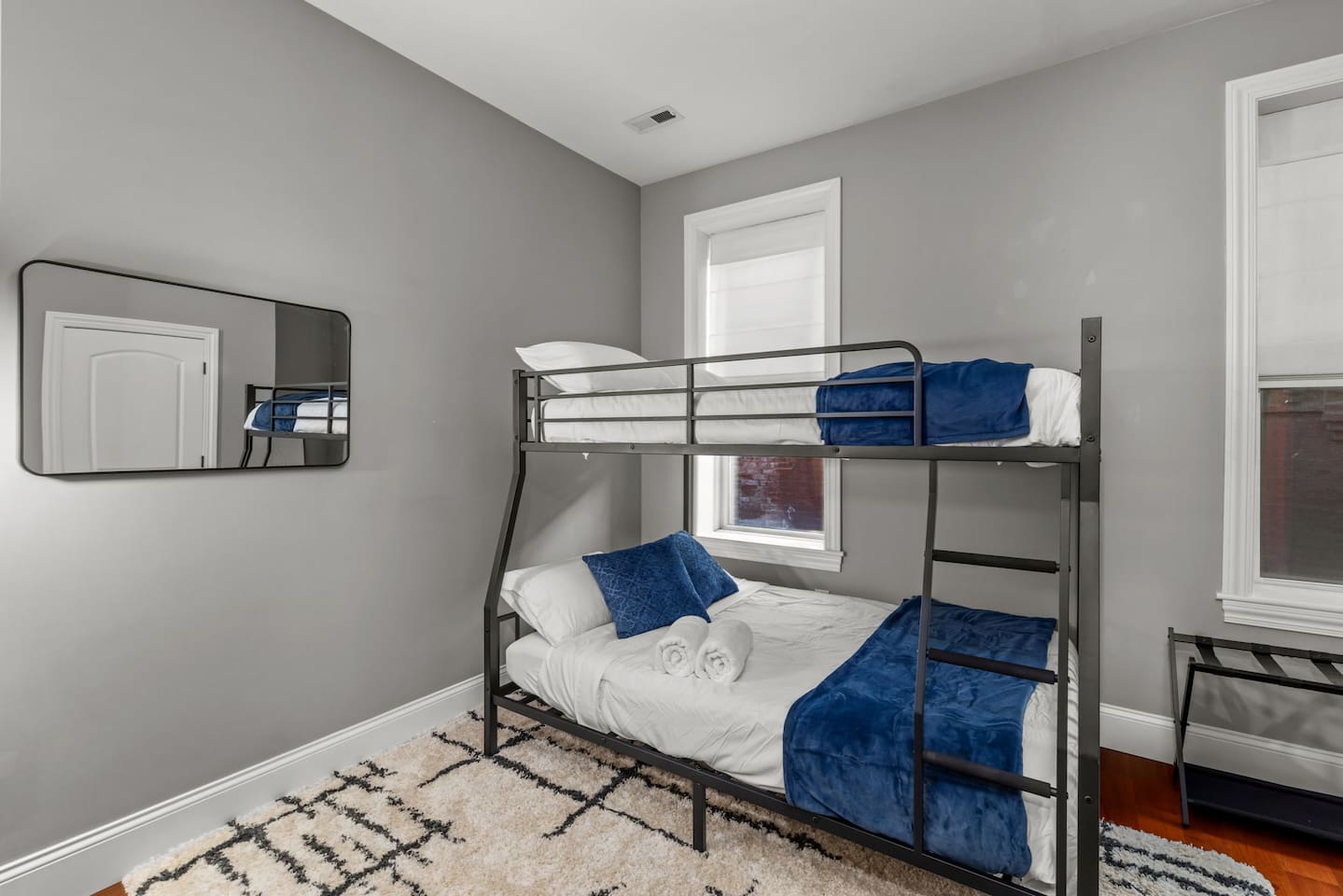 Queen size on lower level, Full XL on upper bunk.  
This is to help accommodate guests who may prefer not to share a bed, though not intended to make room for more than 6 guests total for the property.