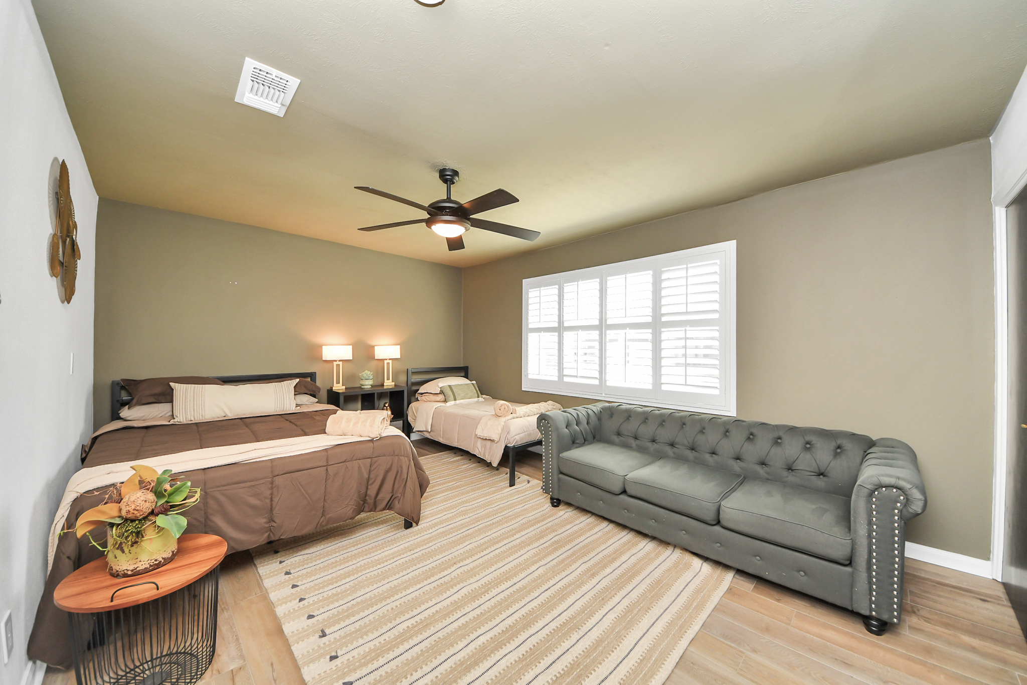 Bedroom #4 is an oversized space complete with a Queen sized bed, twin bed and sofa for a sitting area plus a TV. 