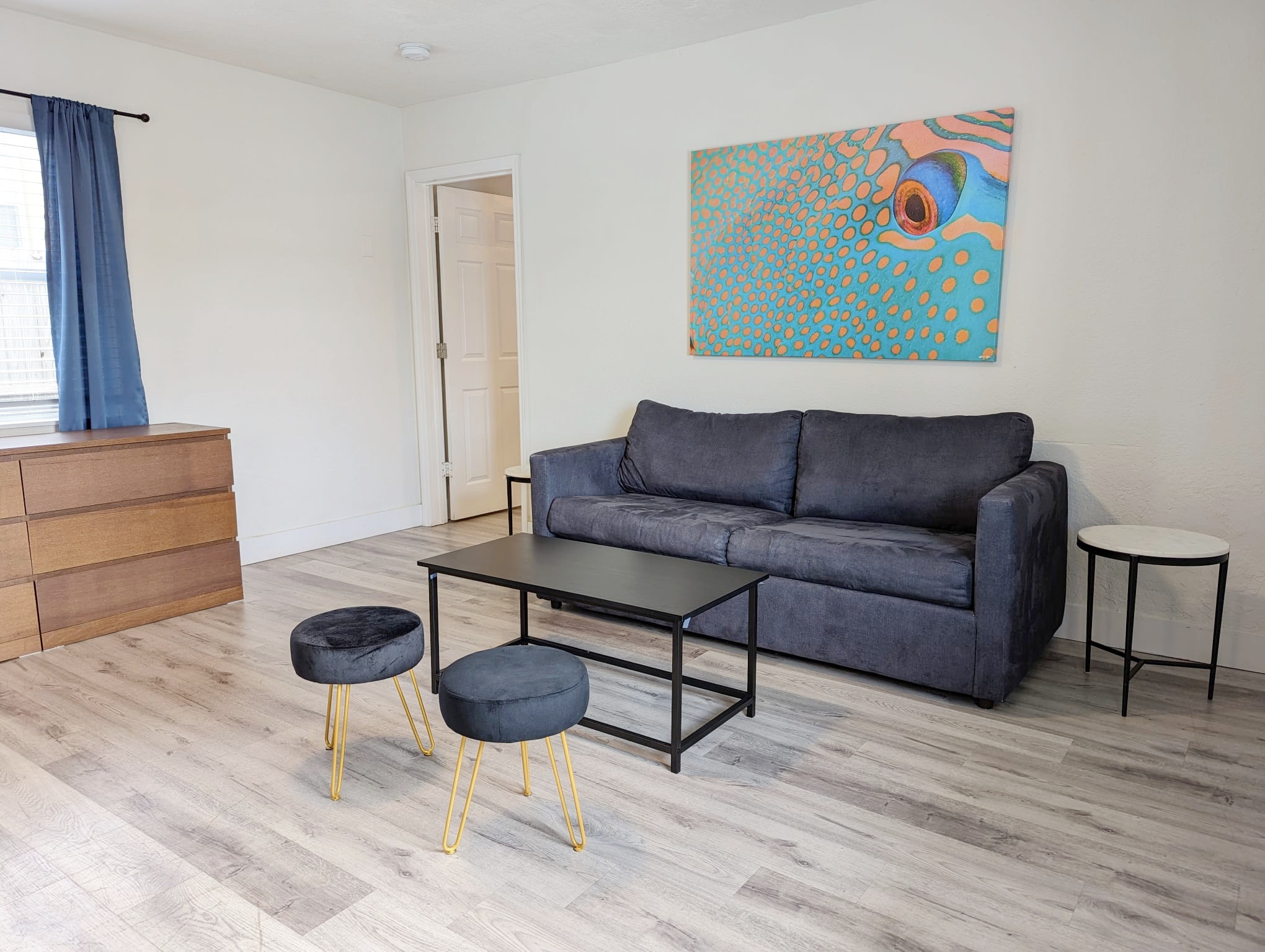 Featuring convertible sofa bed with coffee table and ottomans