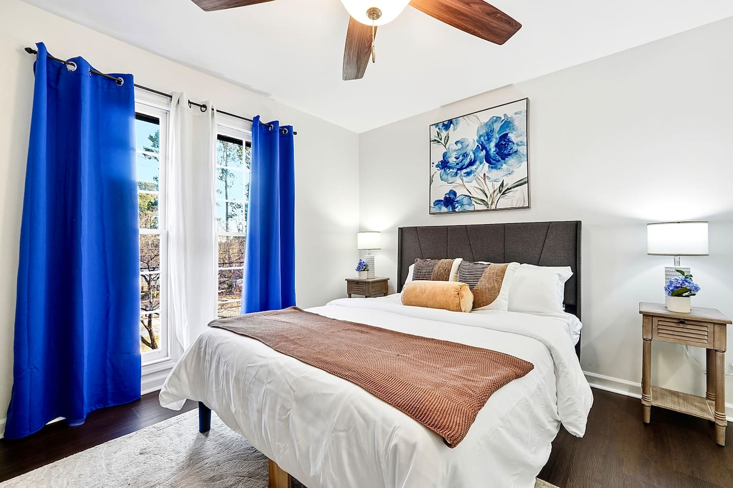 Upstairs bedroom located to the right, featuring a floral-inspired design and a comfortable double bed. Includes a smart TV and easy access to a shared bathroom. This room includes 2 full-body towels, 2 washcloths, and 2 hand towels for your stay.