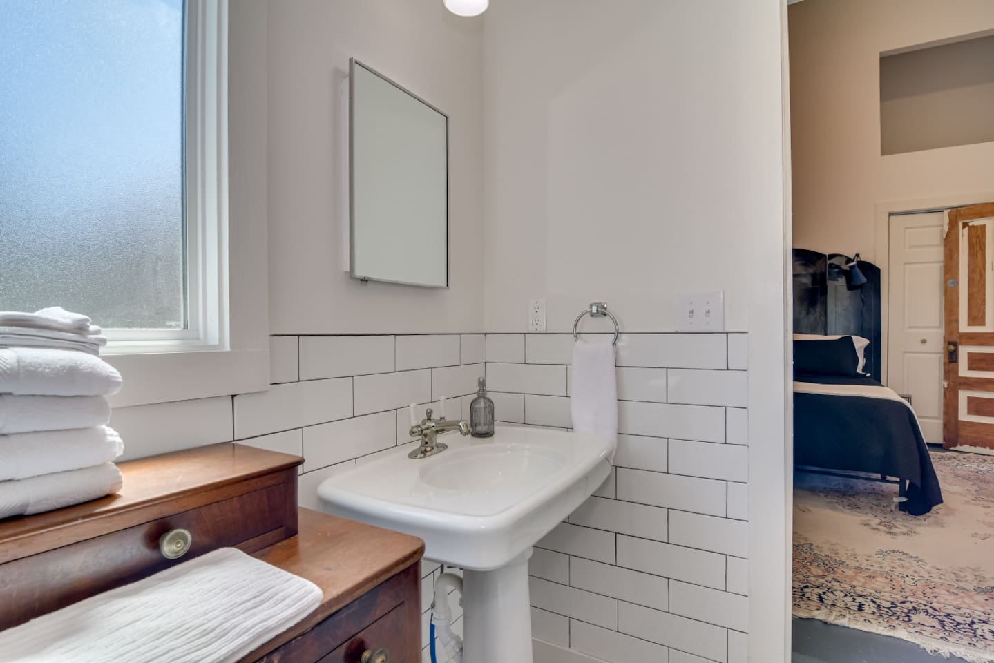 Full bathroom with walk-in shower and modern finishes.