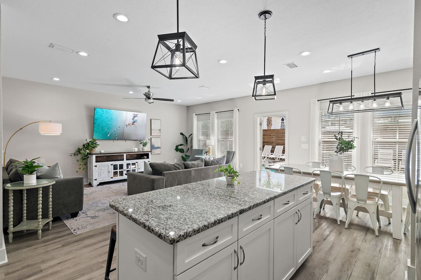 The open-concept living area includes a kitchen island, dining space, and kitchen.