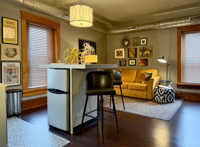 The apartment-size fridge is under the island.