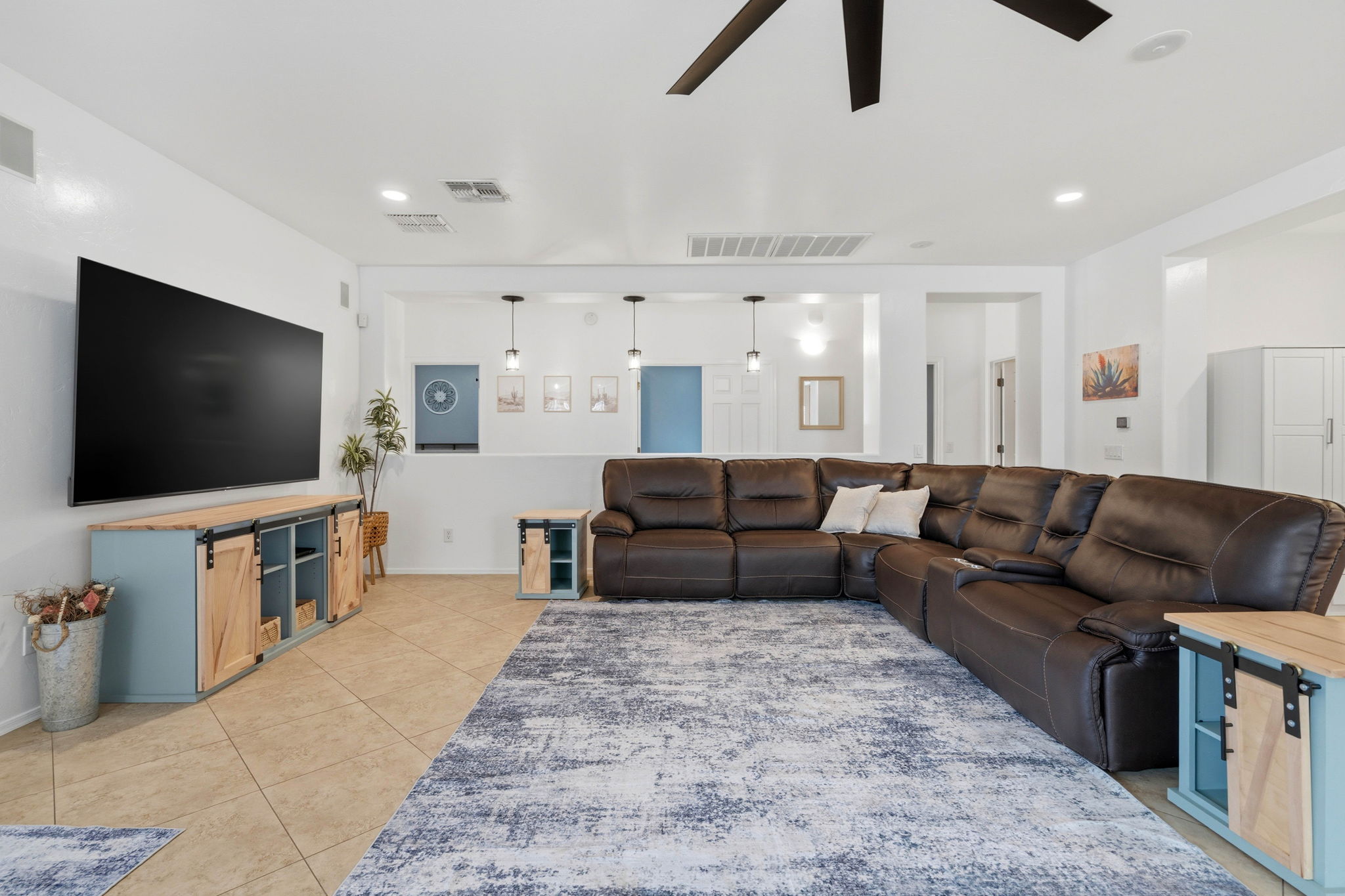 Living Room with Leather Sectional and 85" Smart TV