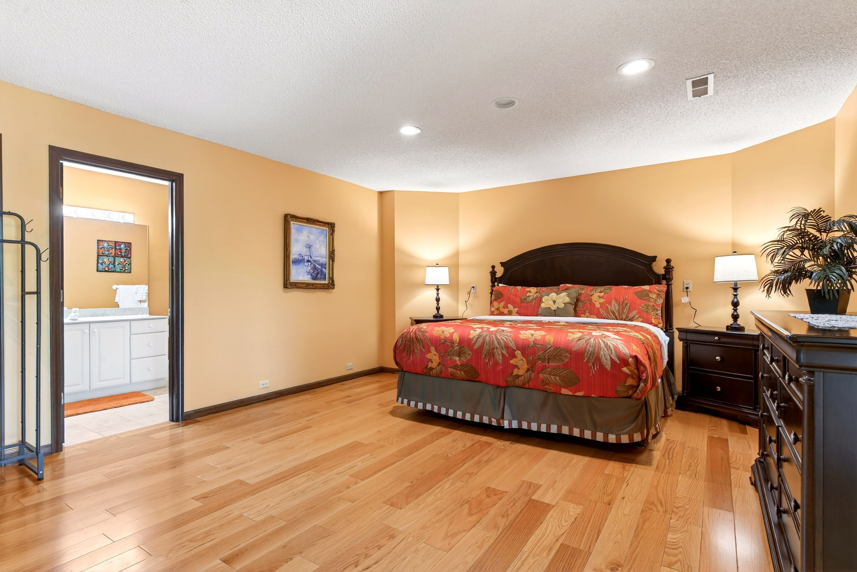 Lower level master bedroom with a king size bed and en-suite bathroom