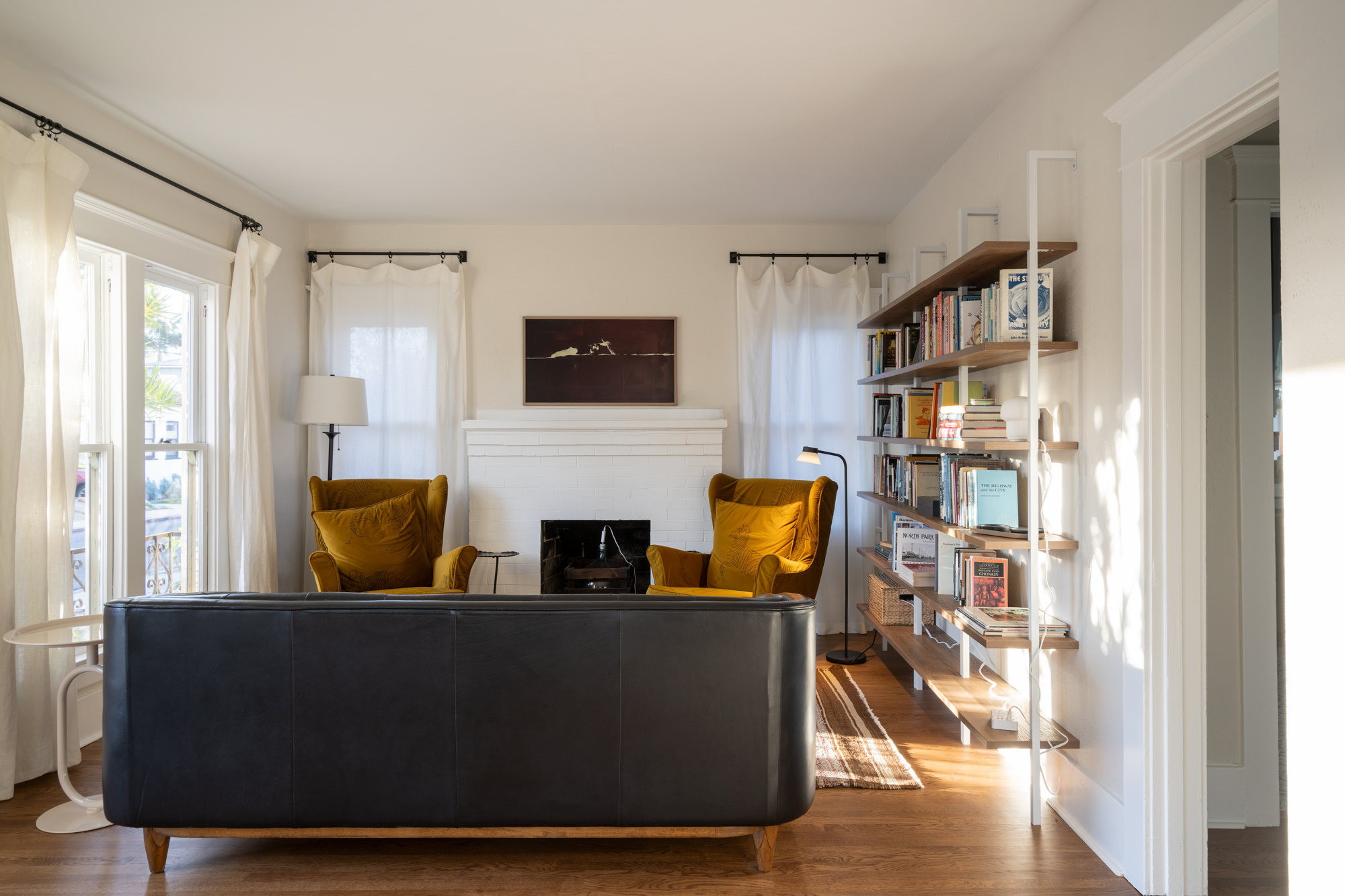 The living room is awash with light and leafy views, and includes a smart TV with art mode.