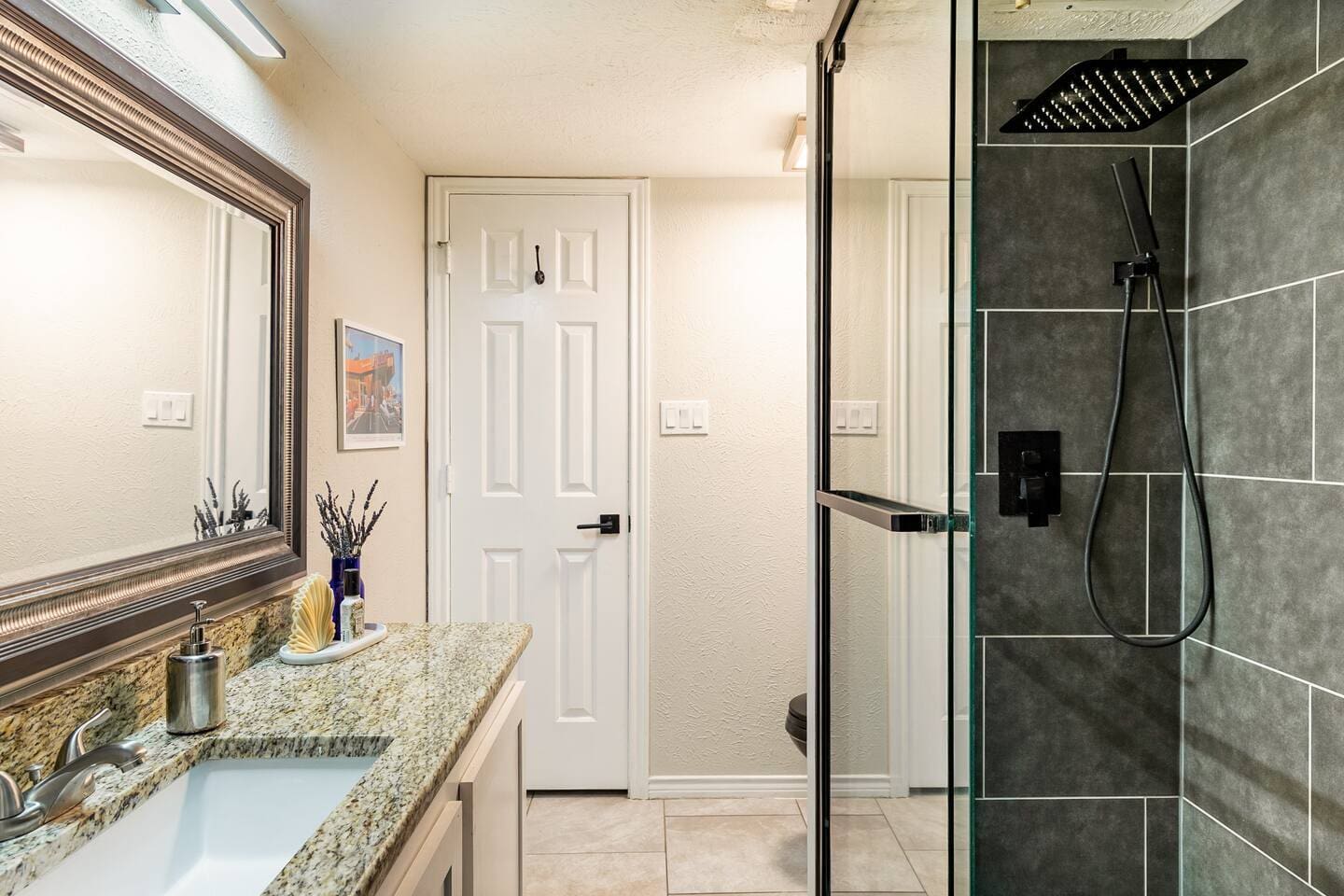 Bathroom with walk-in glass shower and spa-inspired design.