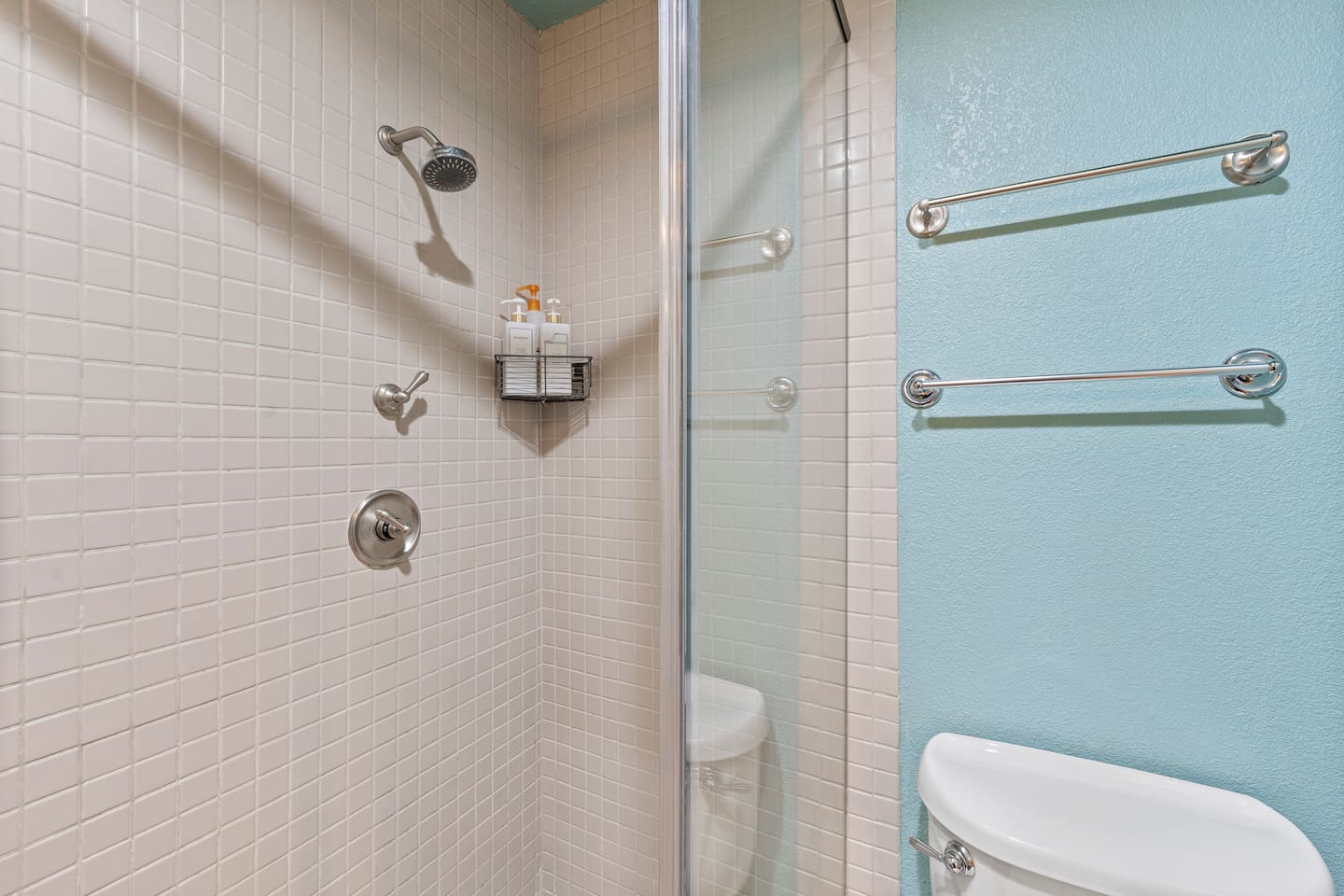 Enjoy a refreshing rinse in the sleek glass-door shower, stocked with complimentary toiletries and fresh towels.