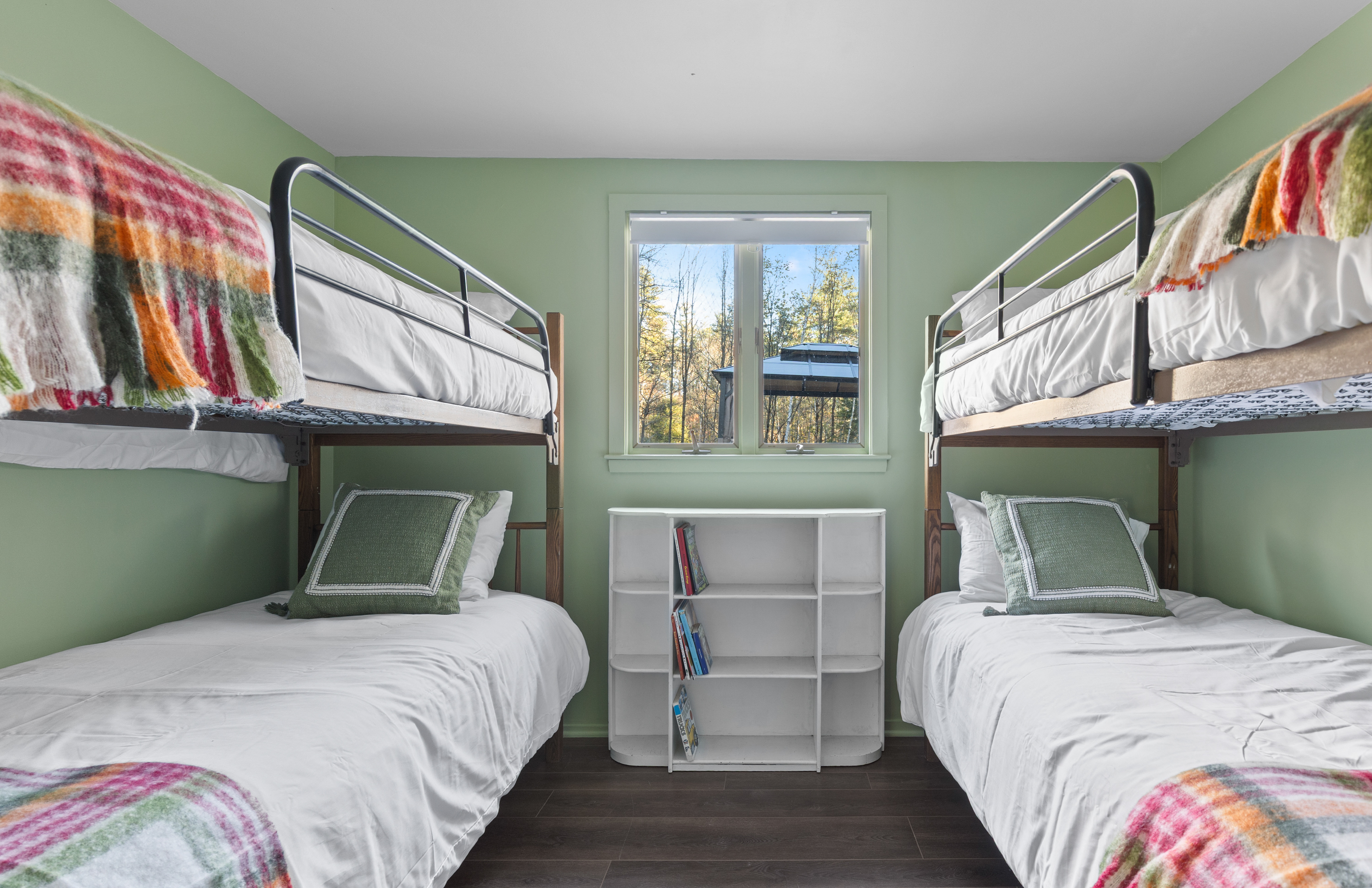 Bunk Room: Bright and spacious with playful decor and serene woodland views awaits your adventure!