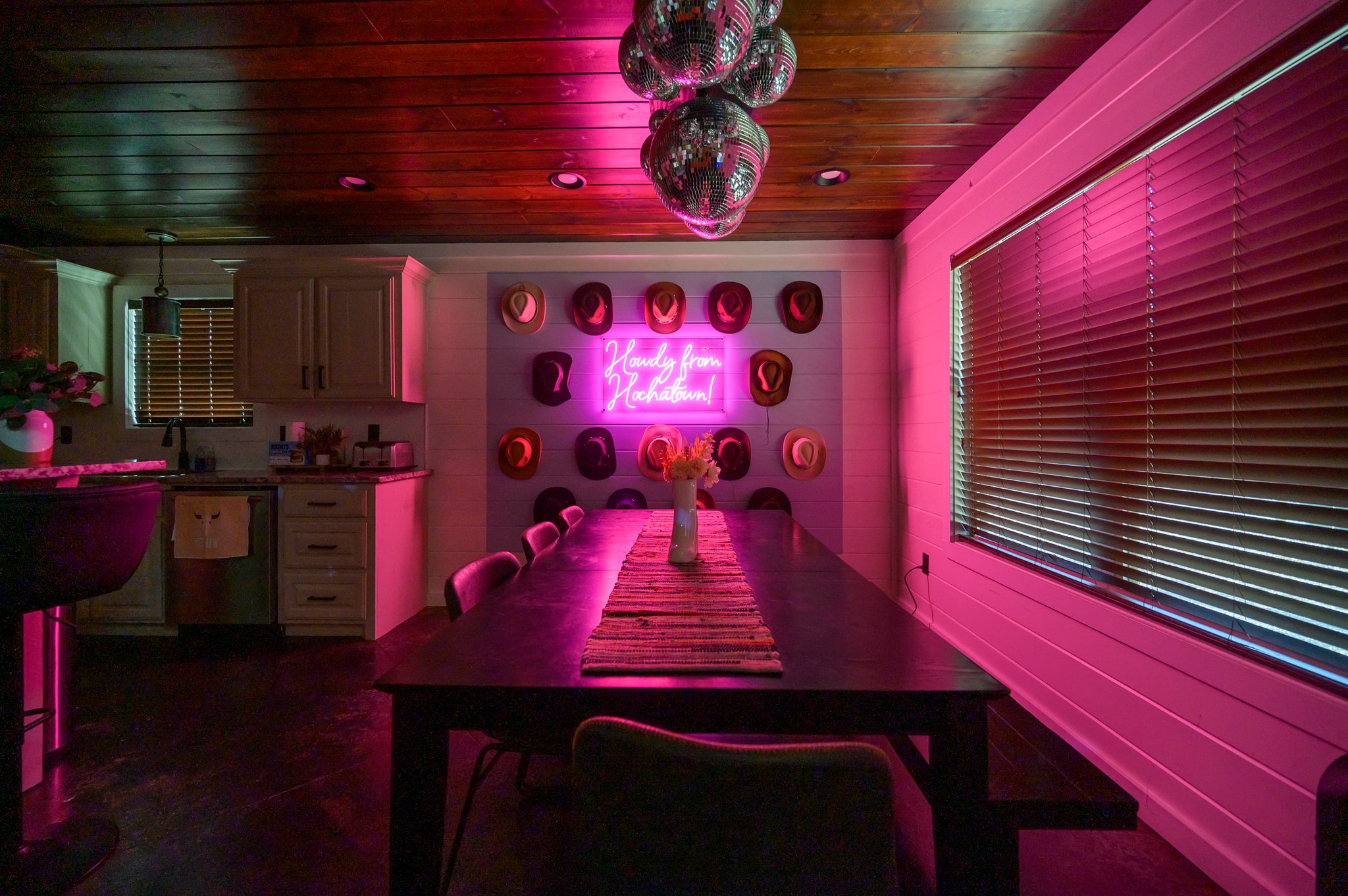 With just the neon sign glowing, the dining area becomes a perfect backdrop for intimate dinners and unforgettable moments.