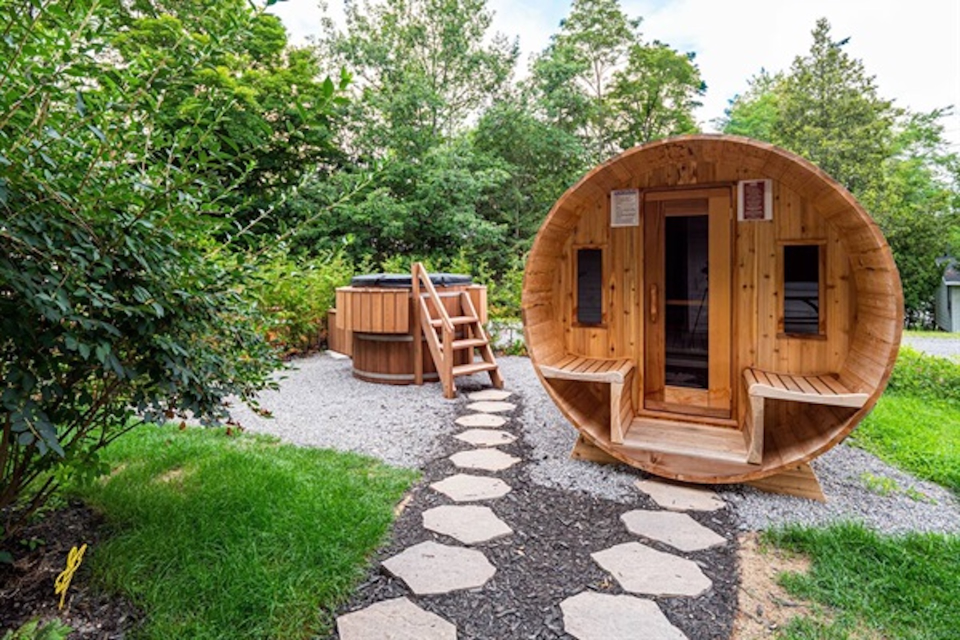 Private barrel sauna surrounded by mature greenery