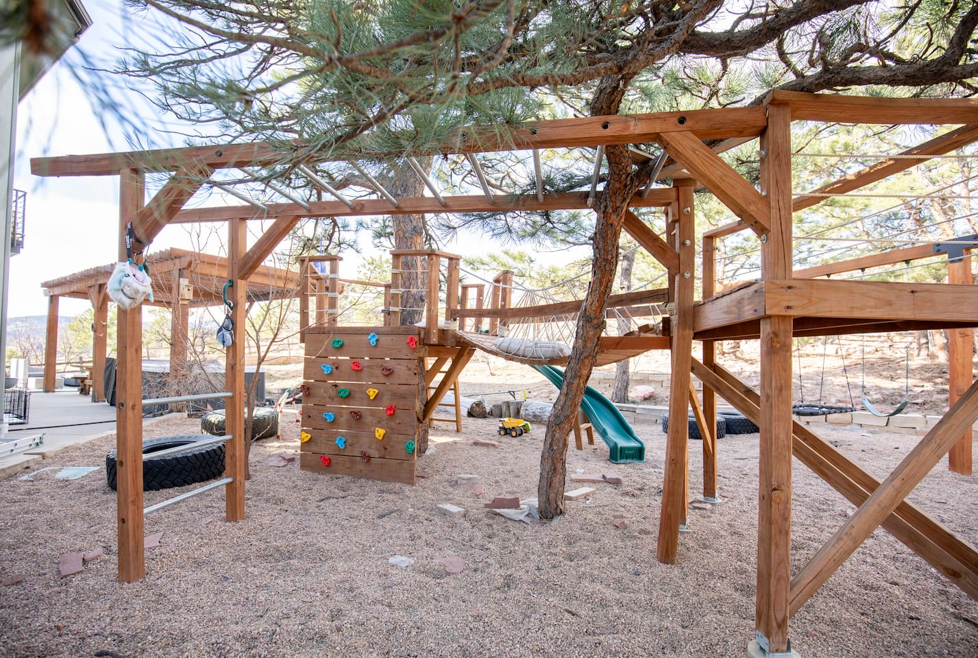Climb, slide, and explore in our custom playground built around a beautiful mature tree. Kids will love the climbing wall, bridge, monkey bars, and slide—creating the perfect backyard adventure right outside the cabin.