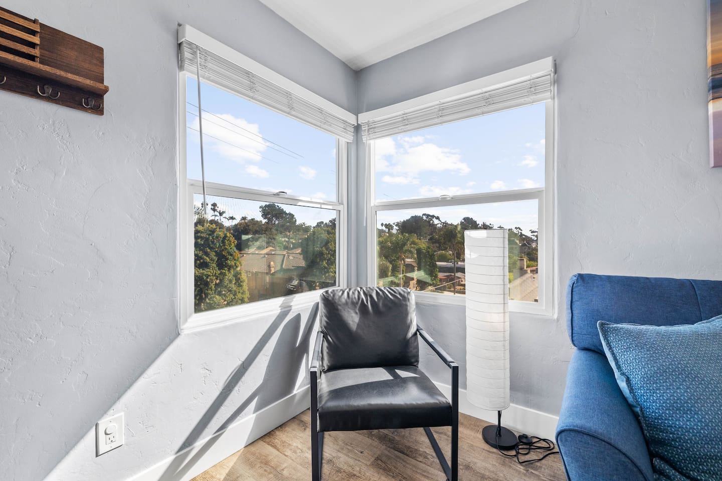 Enjoy a peaceful moment in this cozy nook with a single chair by the window, perfect for solo relaxation and soaking up natural light.