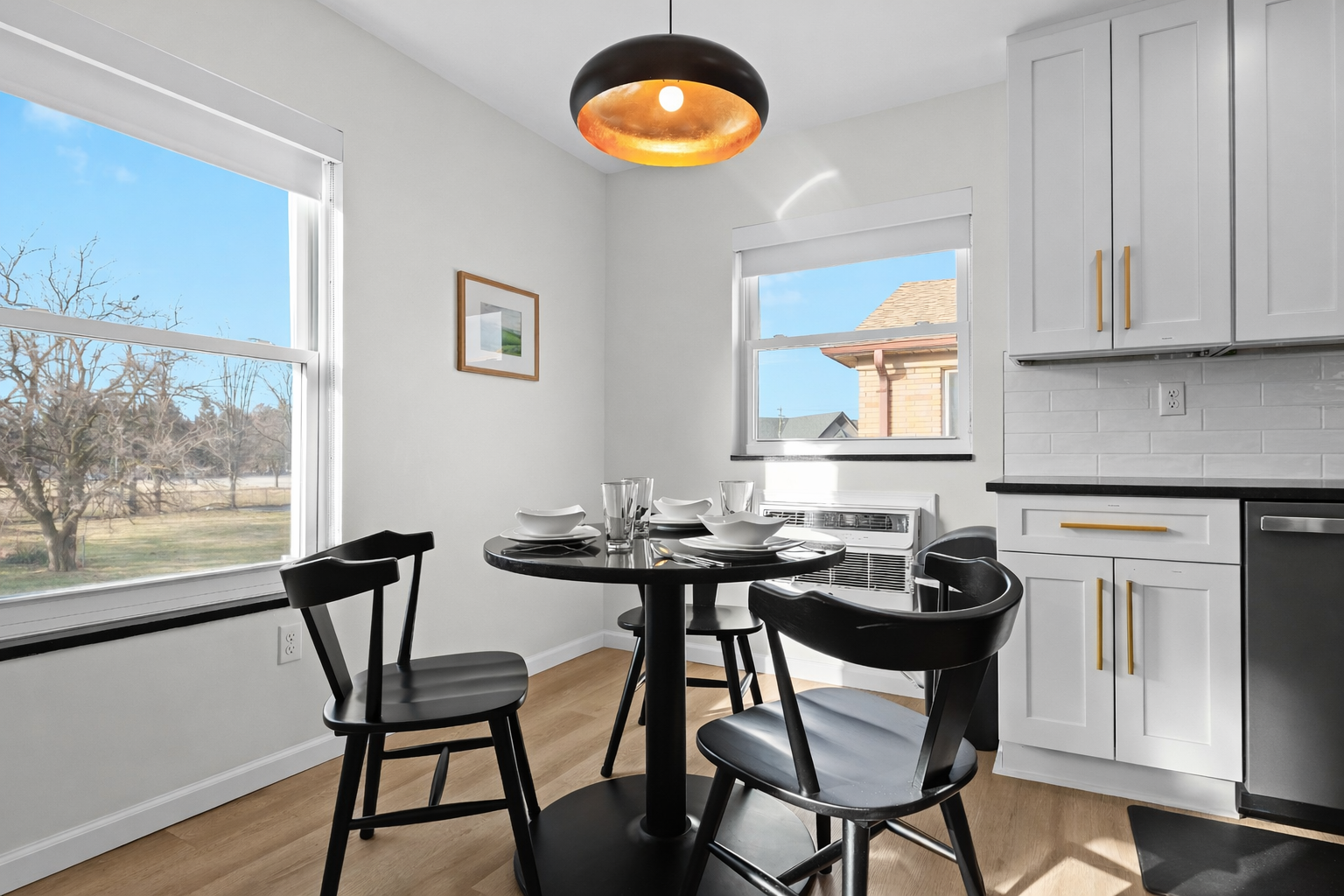 Sunlit dining nook with stylish lighting, cozy seating, and bright windows—perfect for enjoying meals, morning coffee, or relaxed conversations.